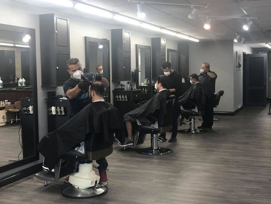 The barber team cutting men's hair. 
