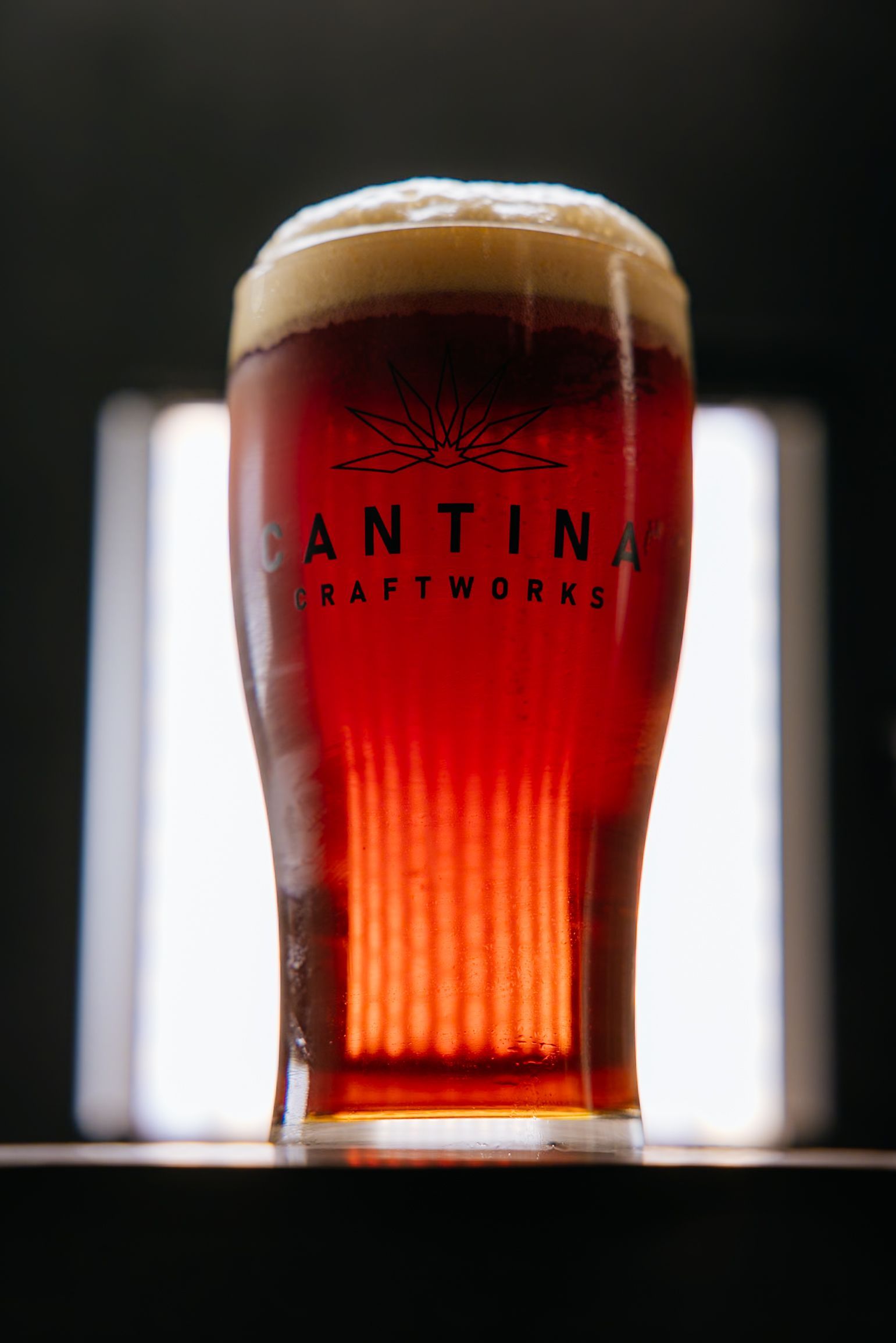 A glass of cantina craftworks beer is sitting on a table
