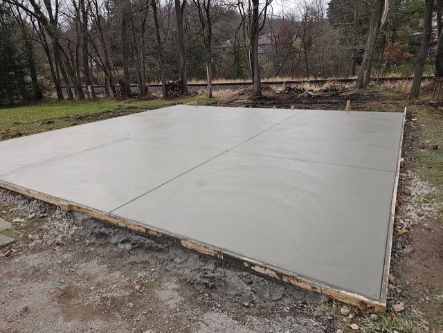A brick driveway leading to a garage with a white garage door, Allison Park, PA, USA, JCM Landscaping