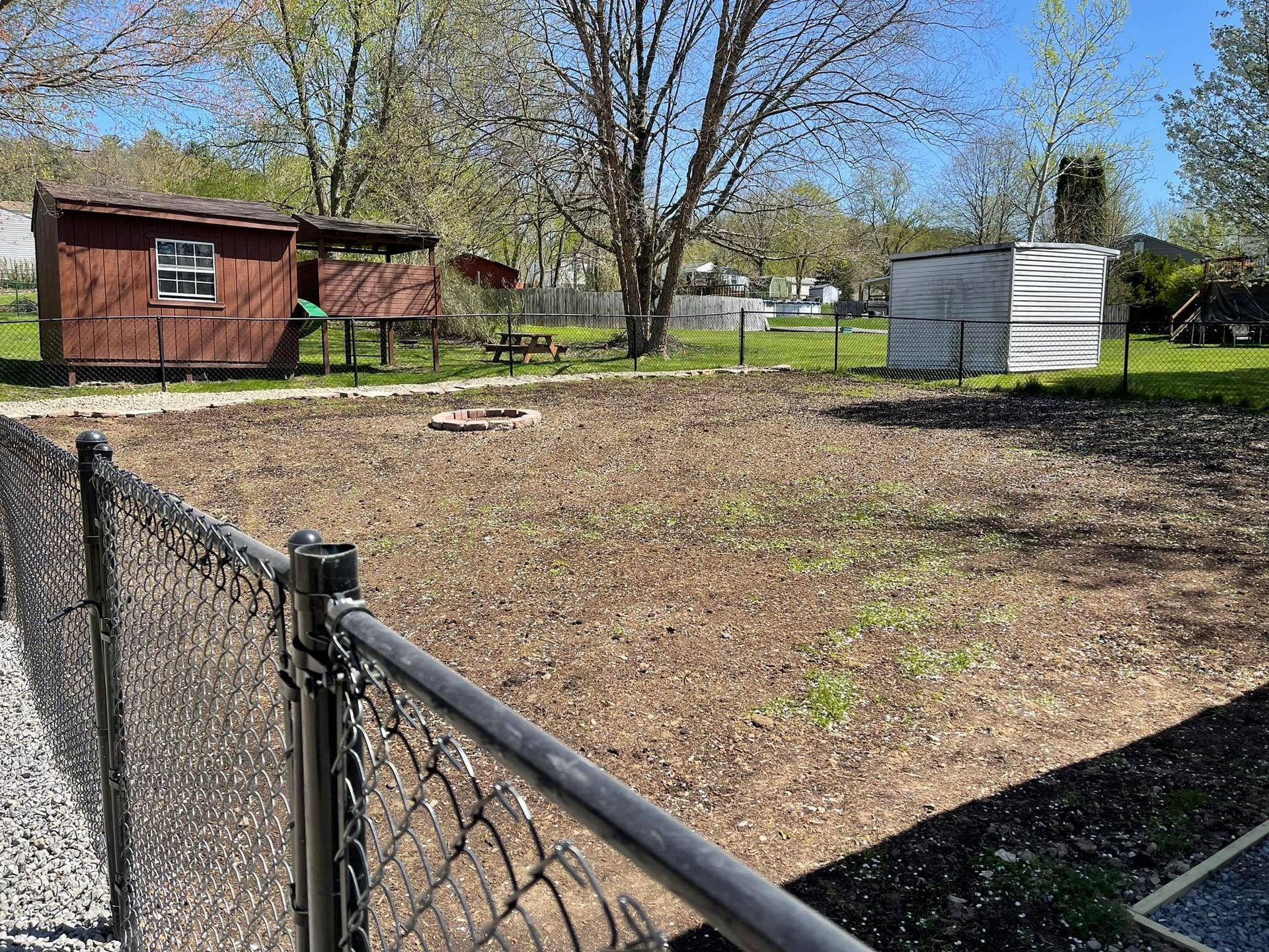 A man is rolling a roll of turf on a lawn, Allison Park, PA, USA, JCM Landscaping