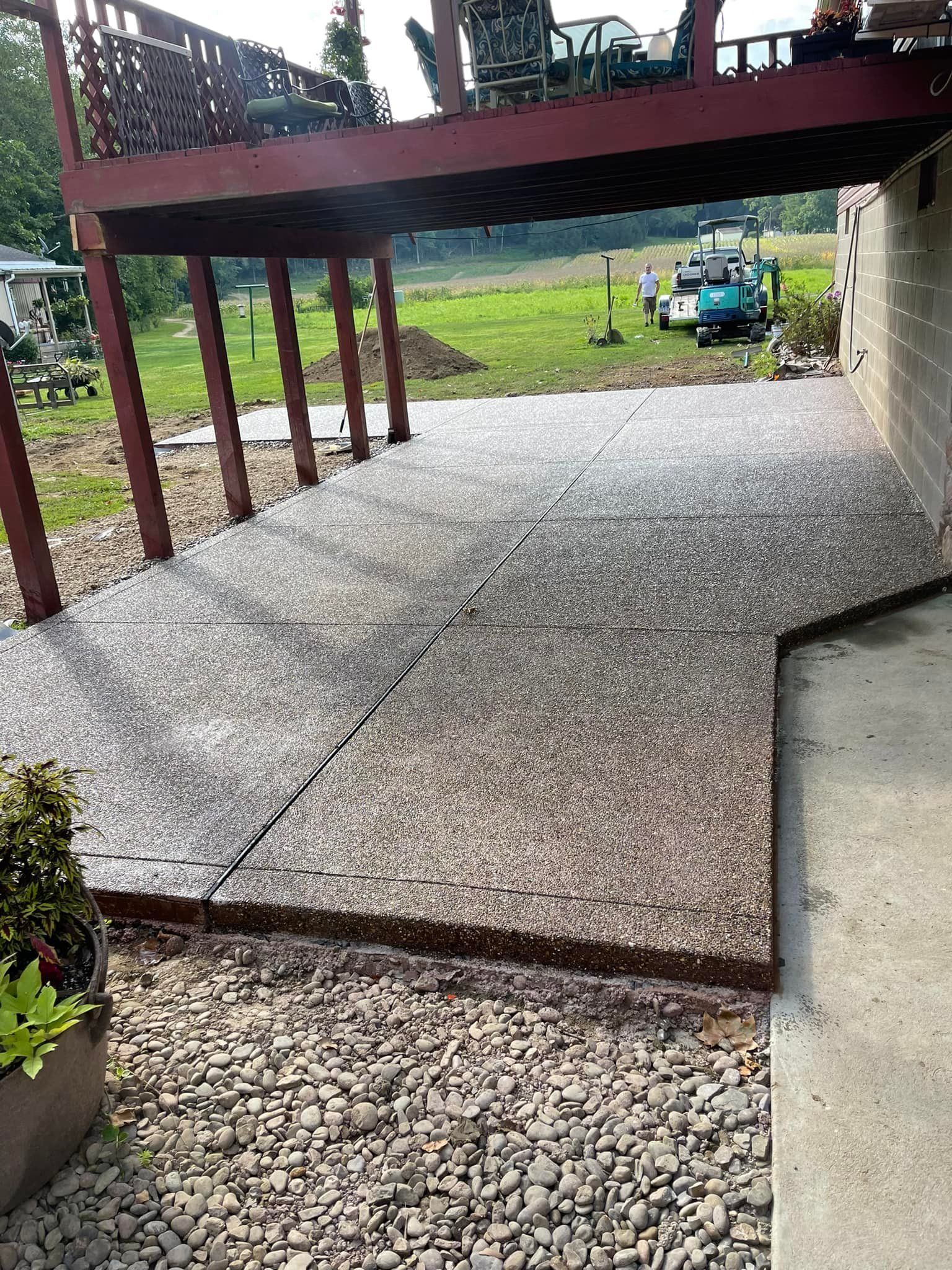 A deck with a table and chairs under an umbrella, Allison Park, PA, USA, JCM Landscaping