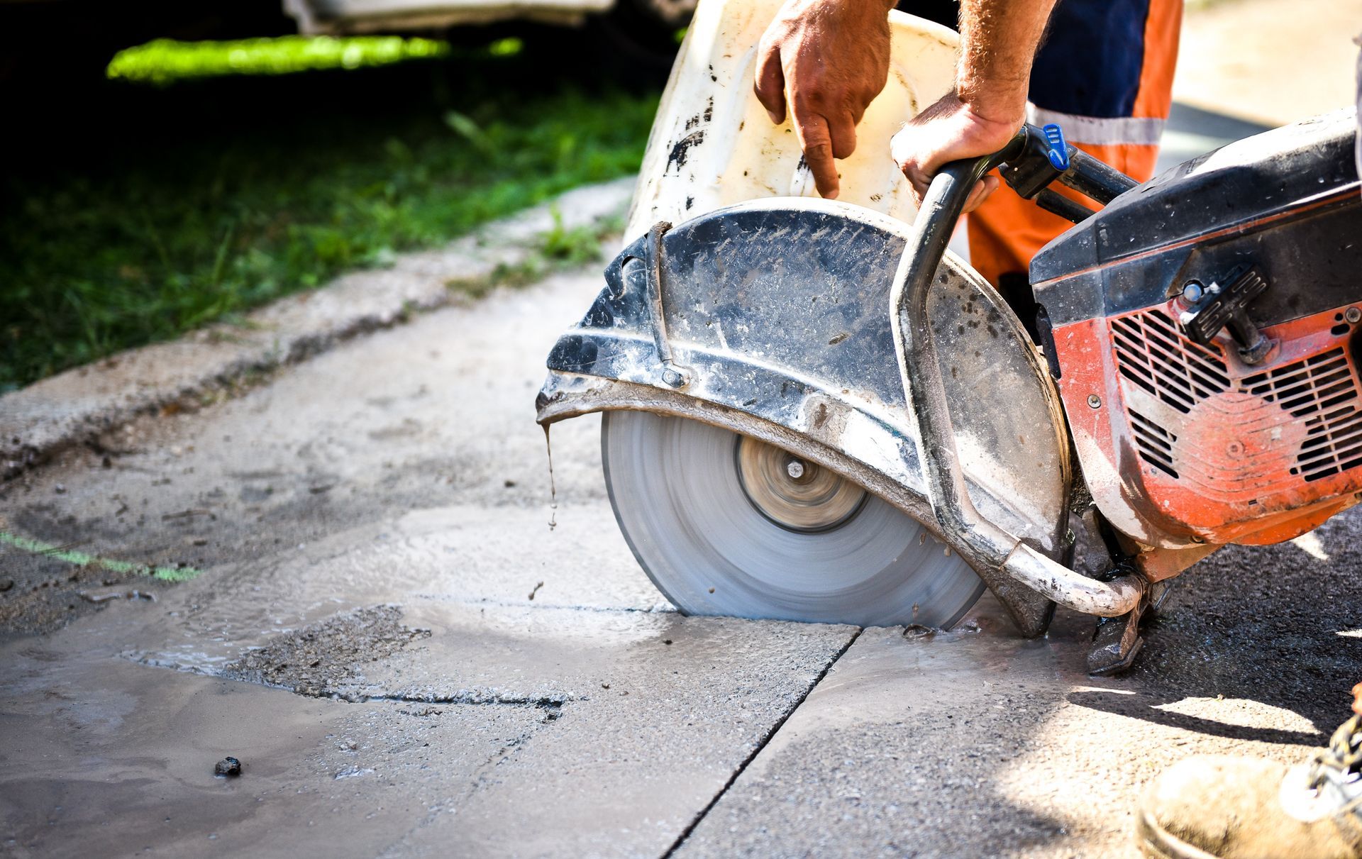 A man is cutting concrete with a circular saw, Allison Park, PA, USA, JCM Landscaping