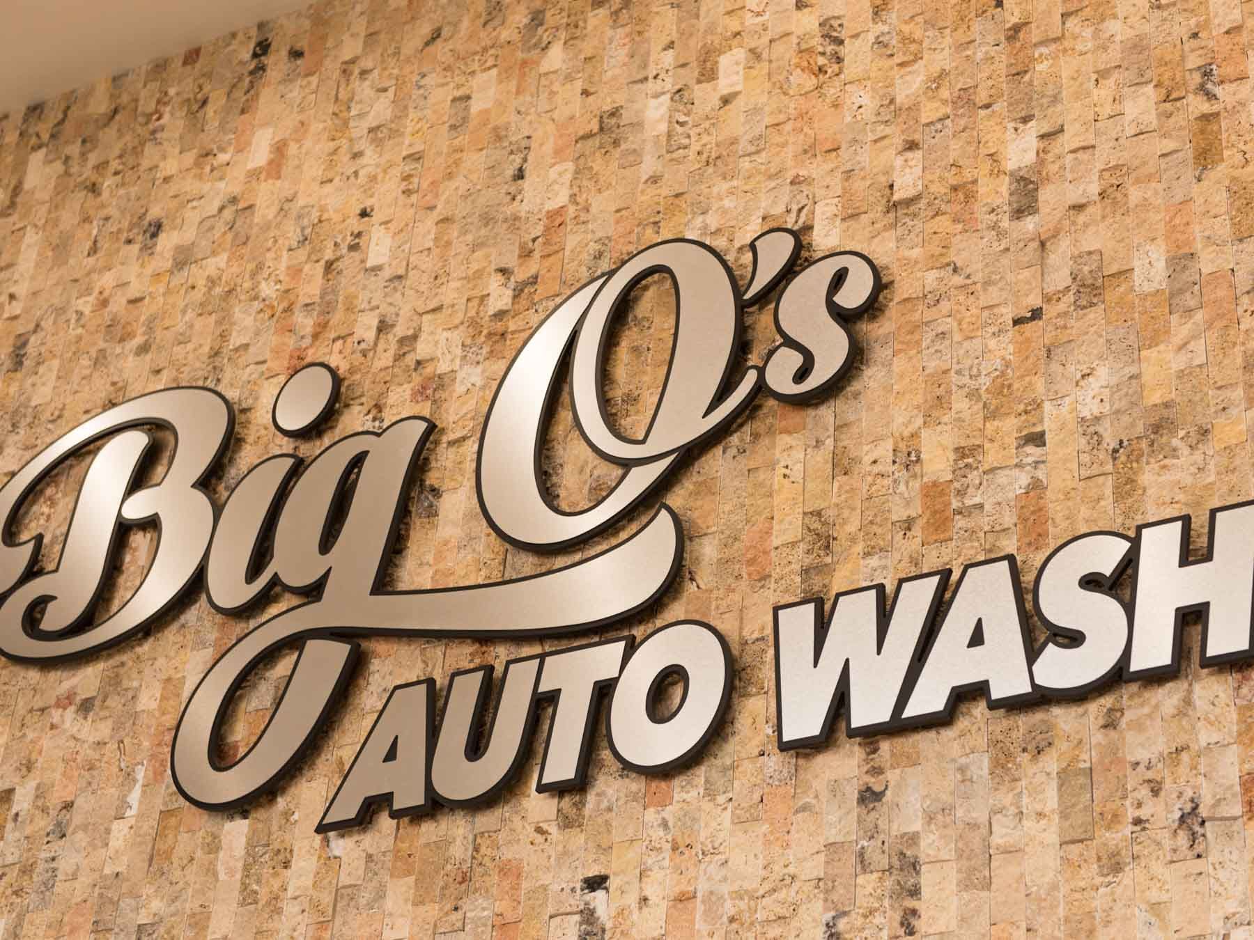 A big o 's auto wash sign on a wall