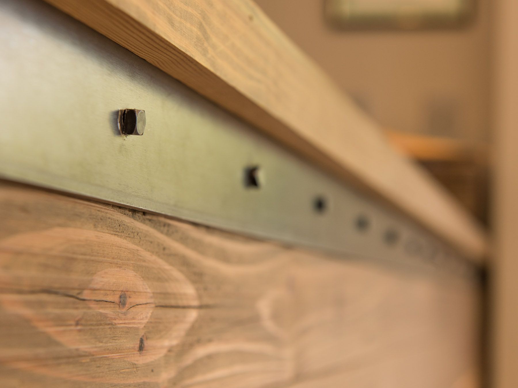 A close up of a wooden surface with a metal border.
