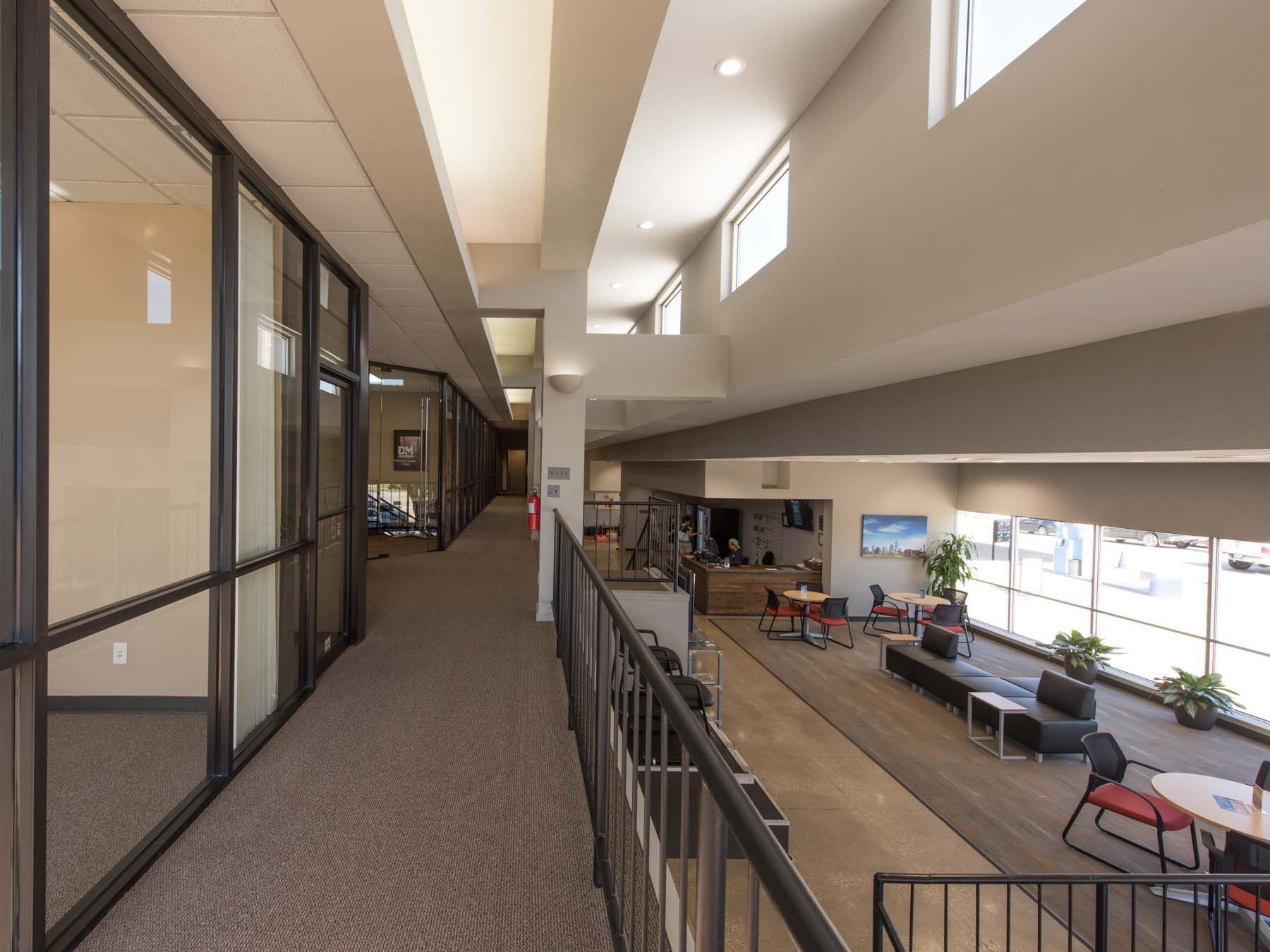 A long hallway in a building with lots of windows