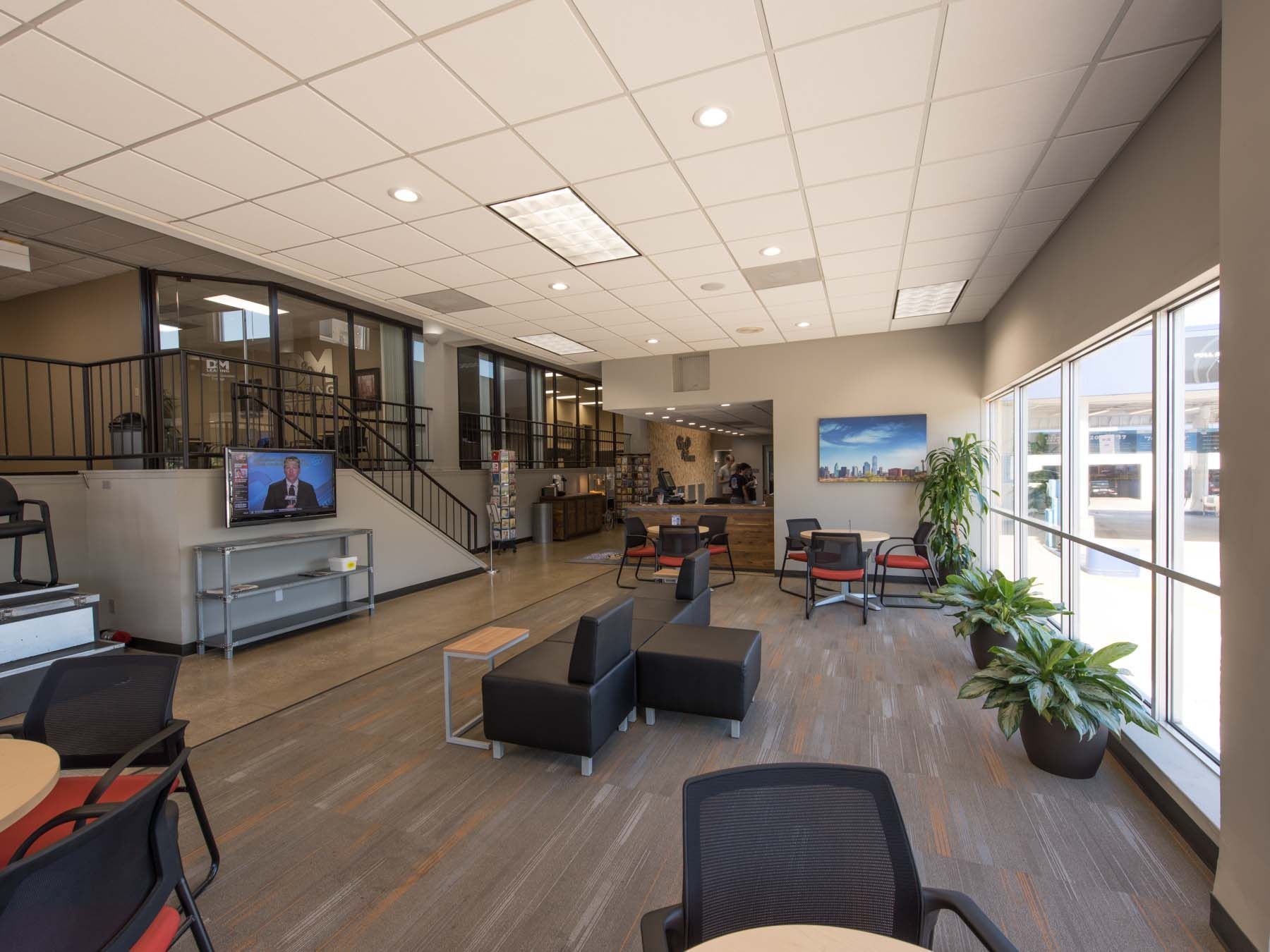 A large room with a lot of windows and furniture