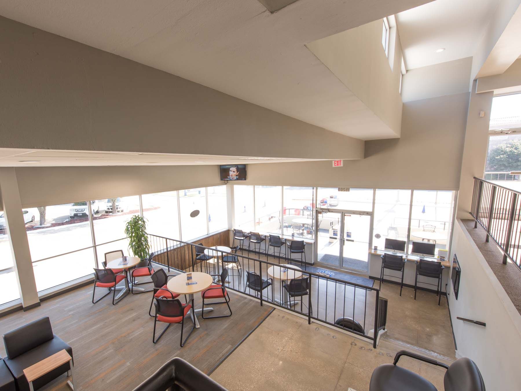 An aerial view of a lobby with tables and chairs.