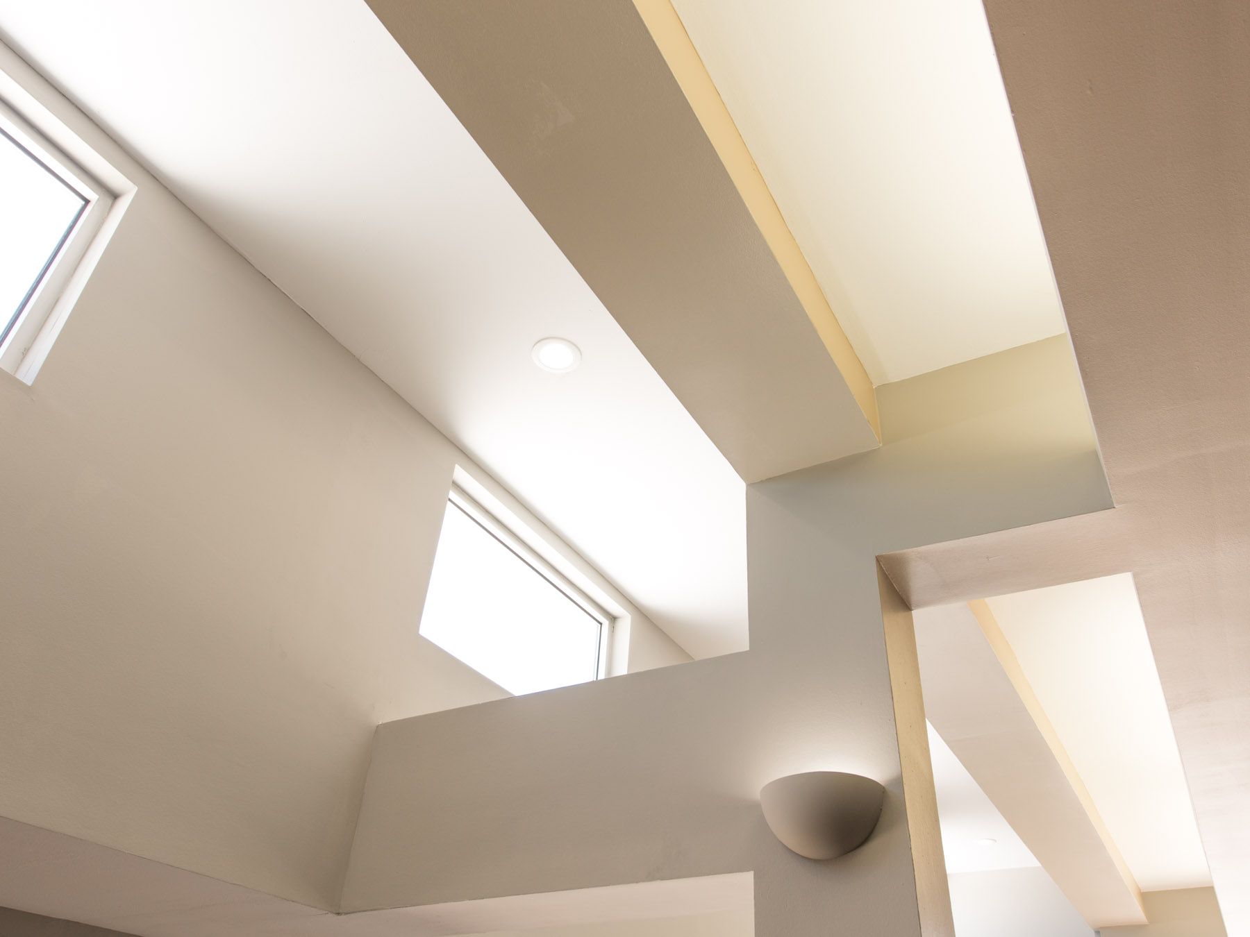 Looking up at the ceiling of a room with a window