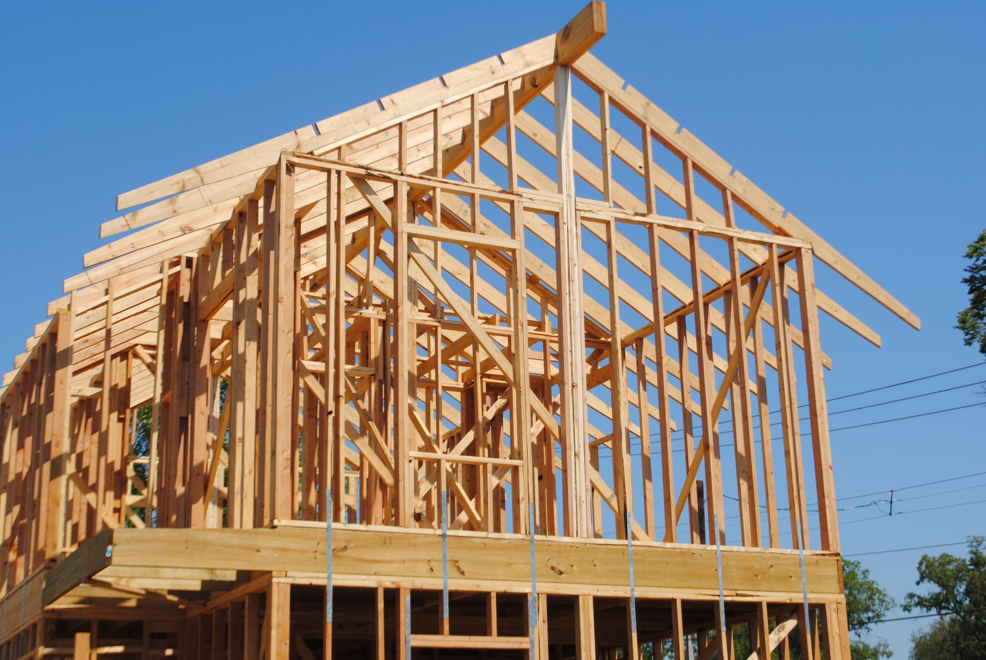 A house is being built with a blue sky in the background