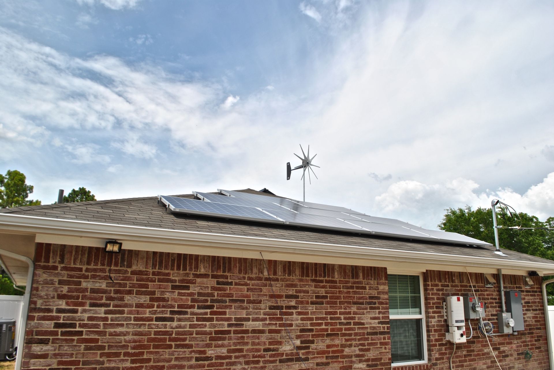 A brick house with solar panels on the roof.