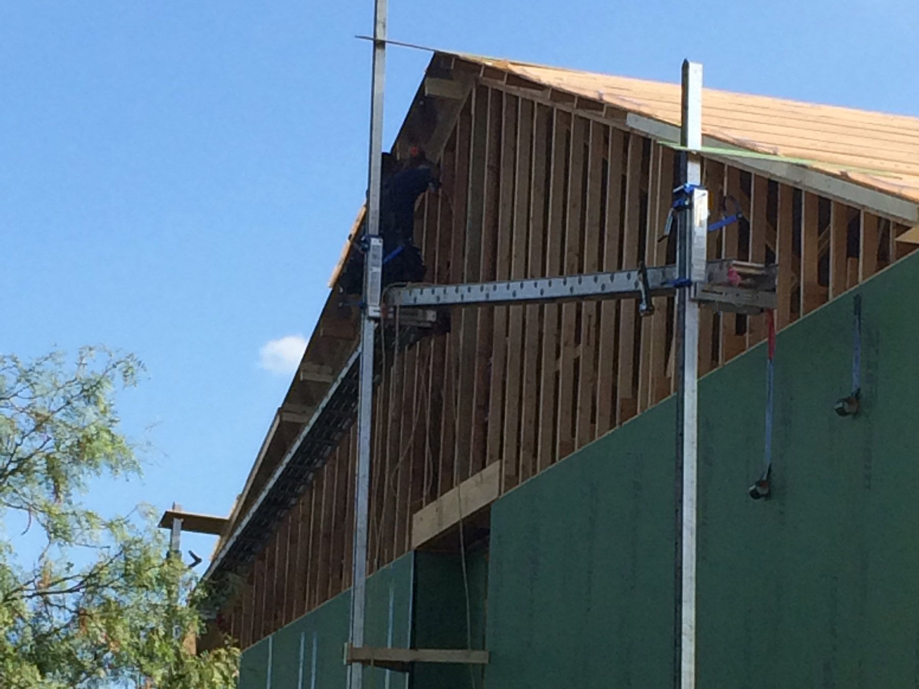 A man is working on the side of a building.
