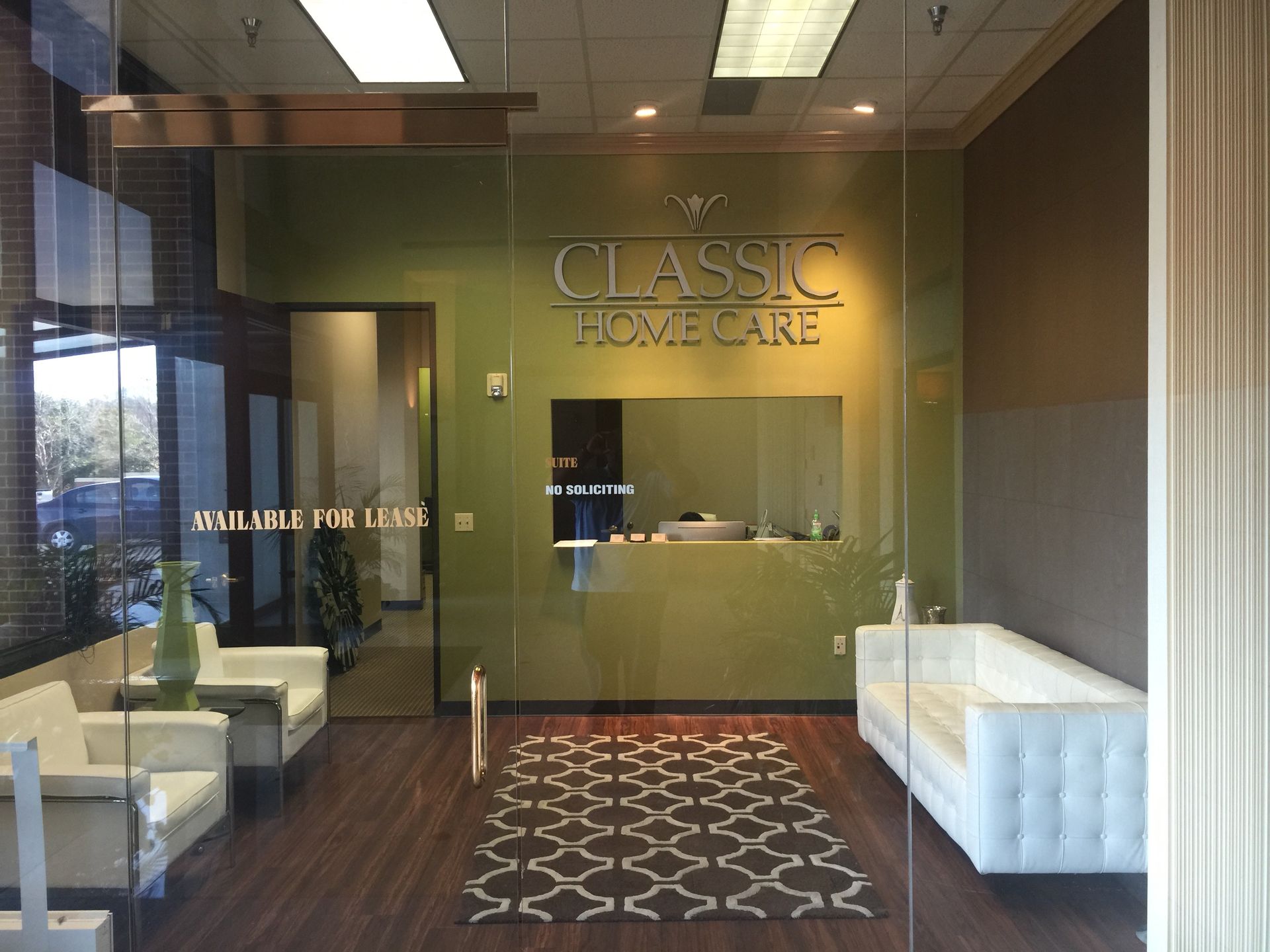 A classic home care waiting room with a couch and chairs