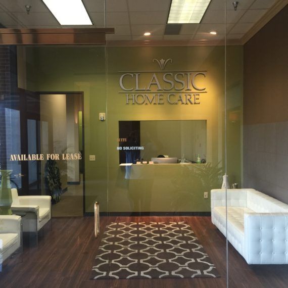 A man in a yellow vest is standing on the roof of a building