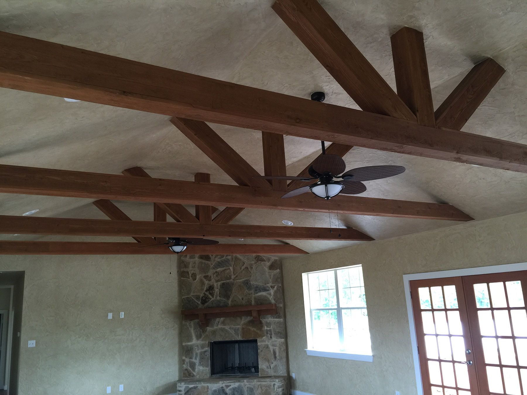 A living room with a fireplace and ceiling fan