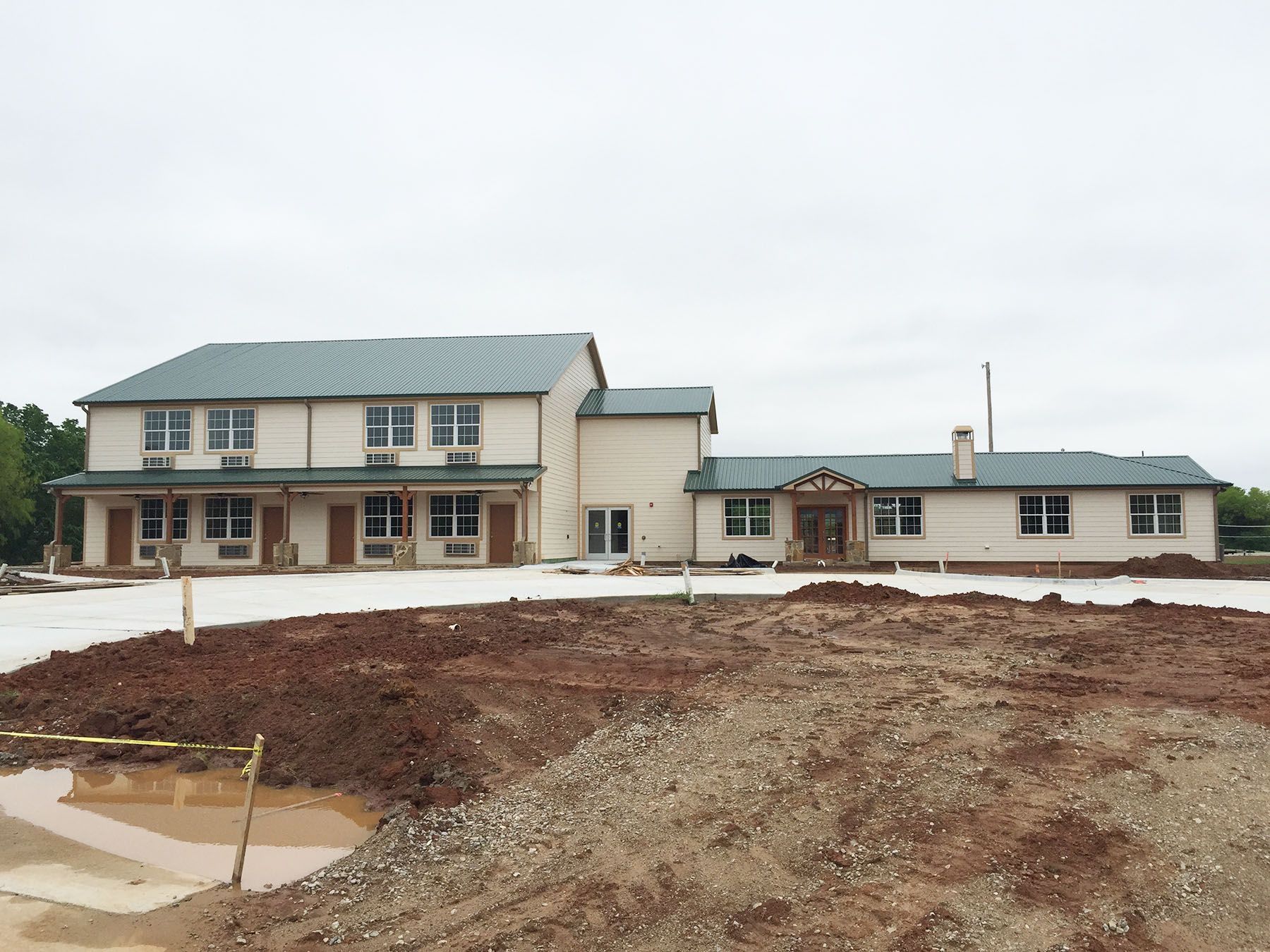 A large house with a lot of dirt in front of it