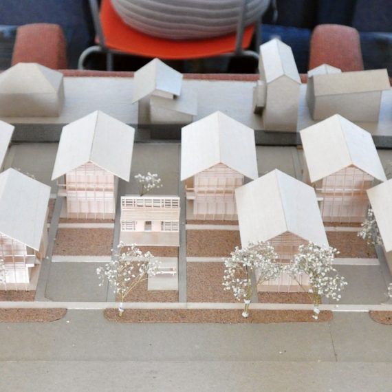 A model of a row of houses with white roofs