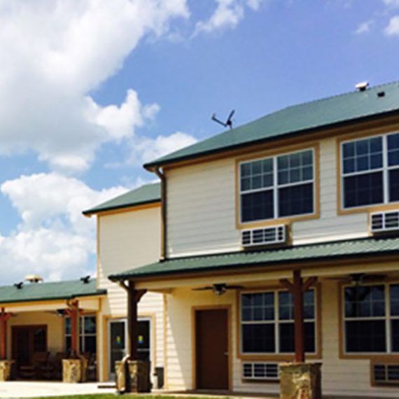 A modern house with a dark garage, large windows, and a stone-accented porch.
Ask ChatGPT