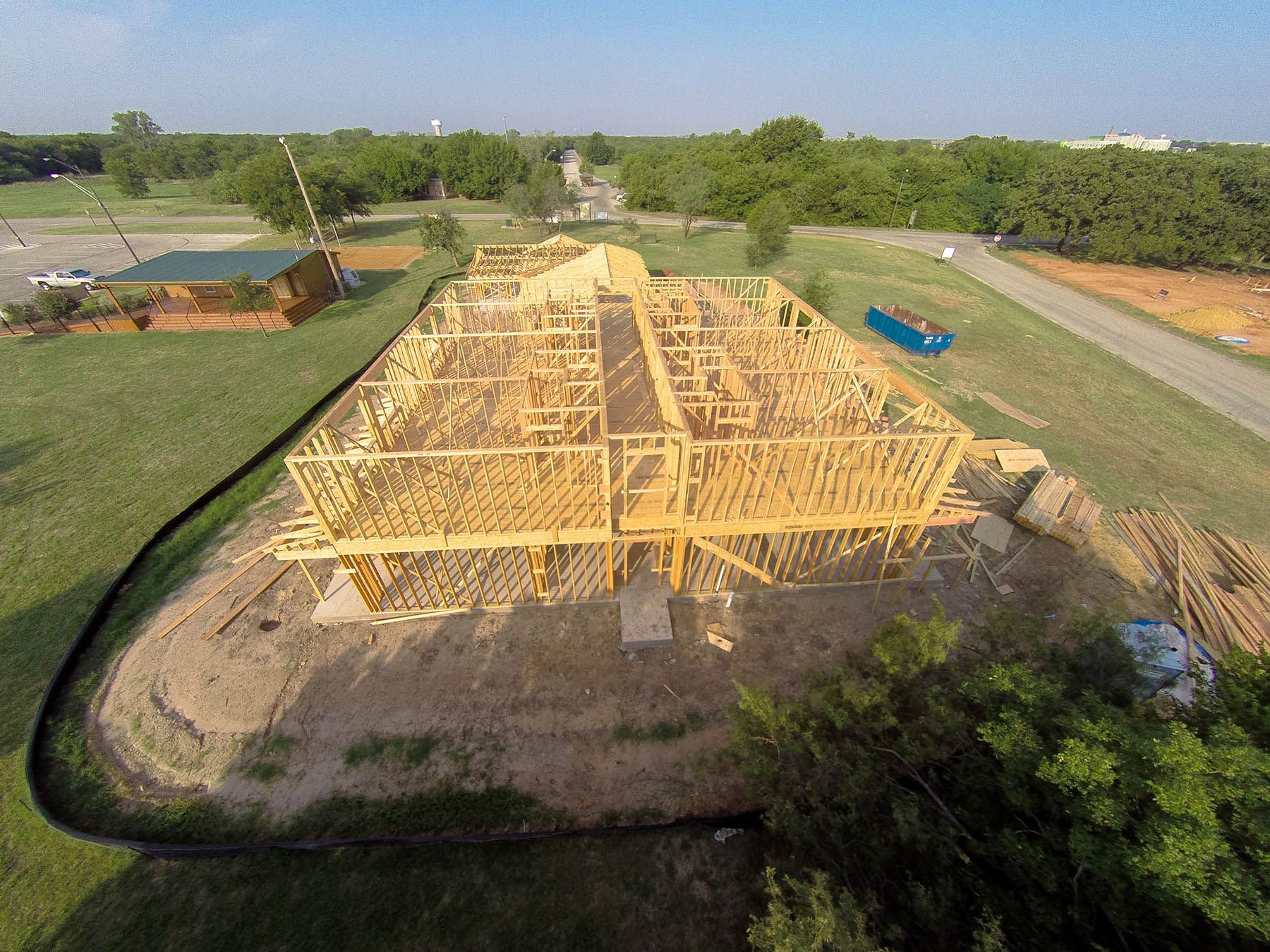An aerial view of a house under construction in a field.