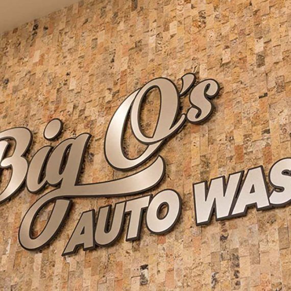 A big o 's auto wash sign on a wall