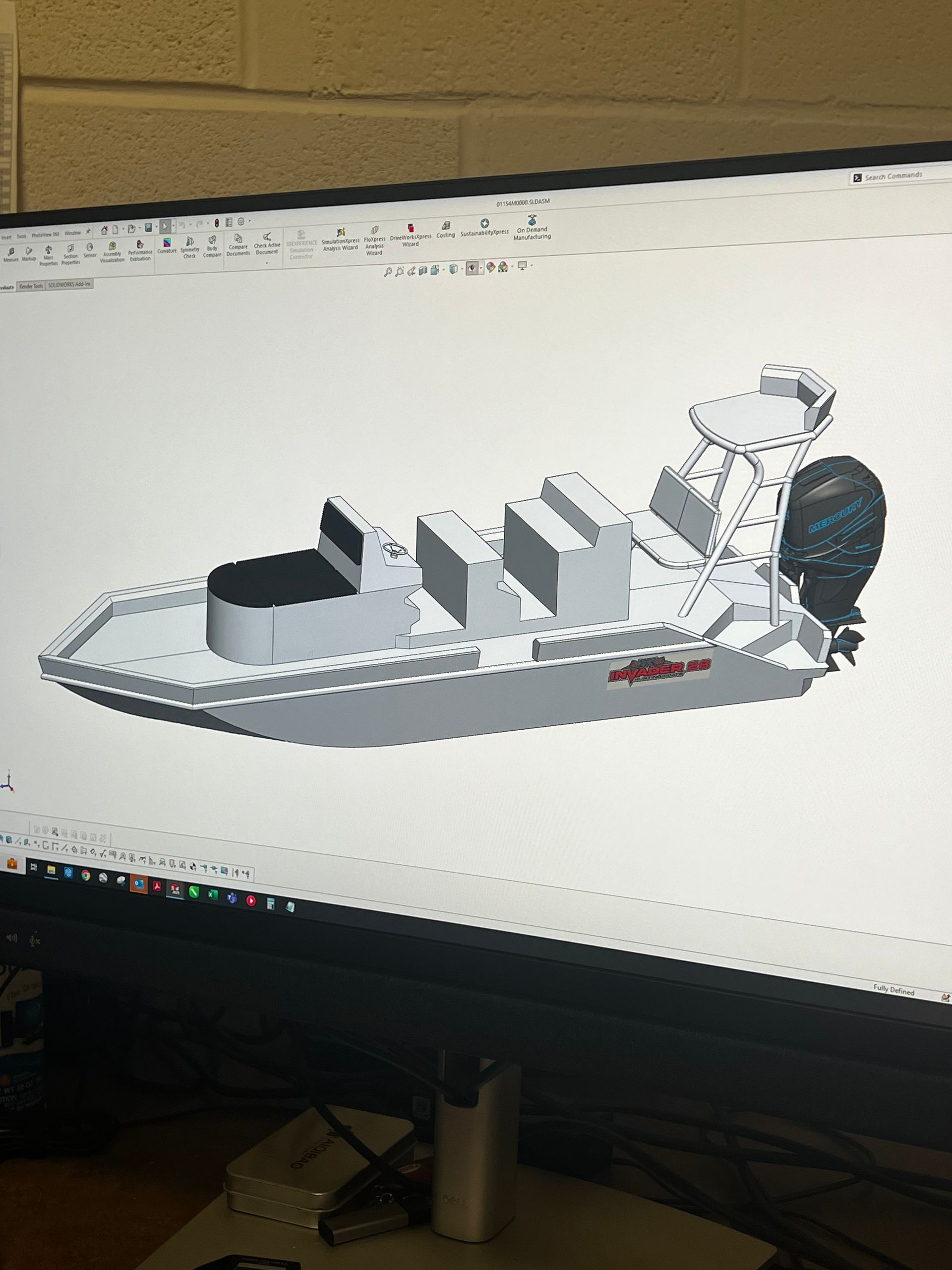 A computer monitor with a model of a boat on it