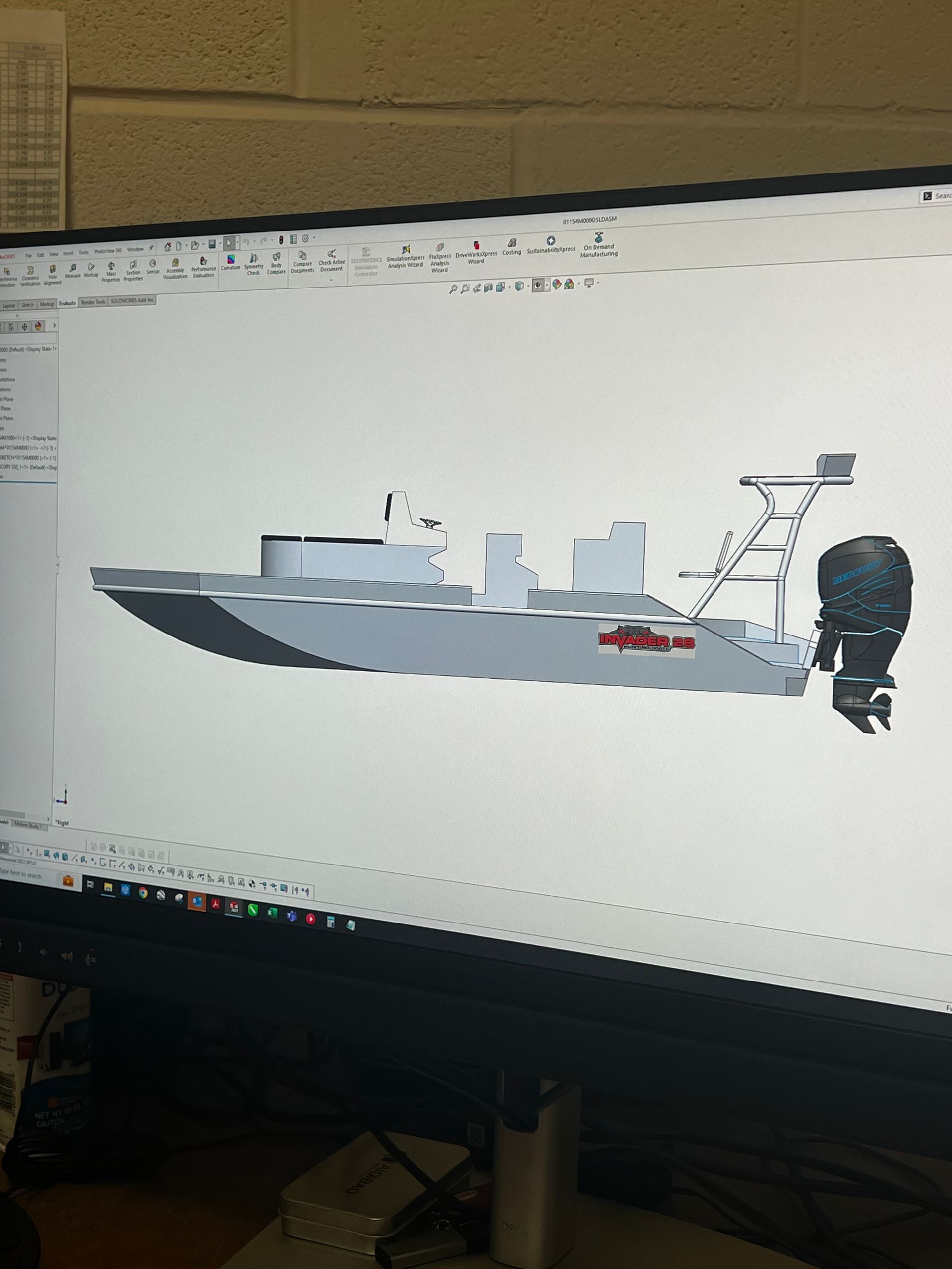 A computer monitor displays a 3d drawing of a boat