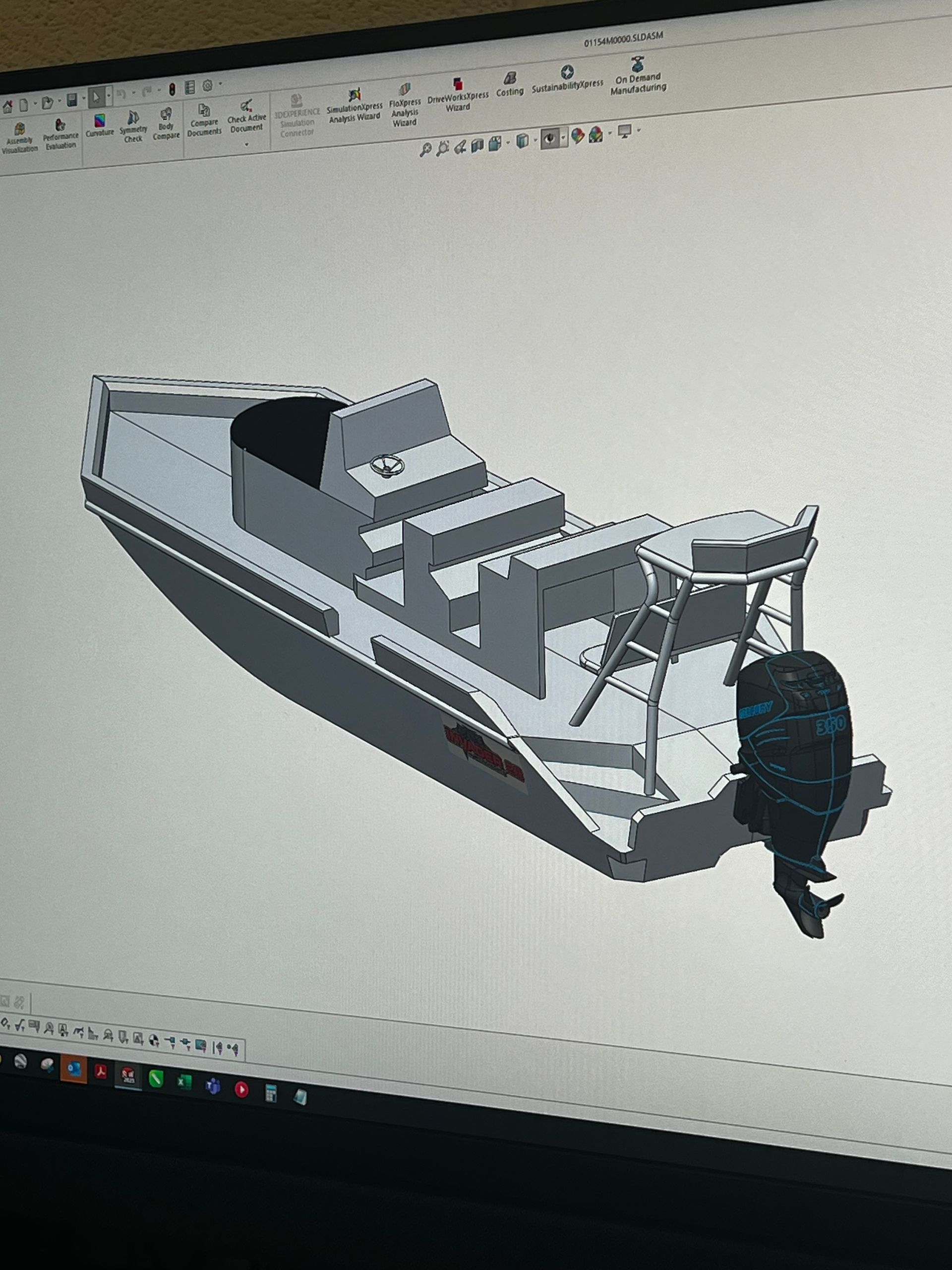 A computer screen shows a 3d model of a boat