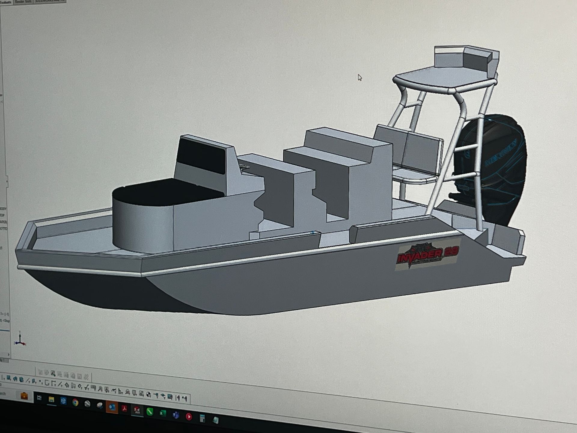 A computer screen shows a 3d model of a boat