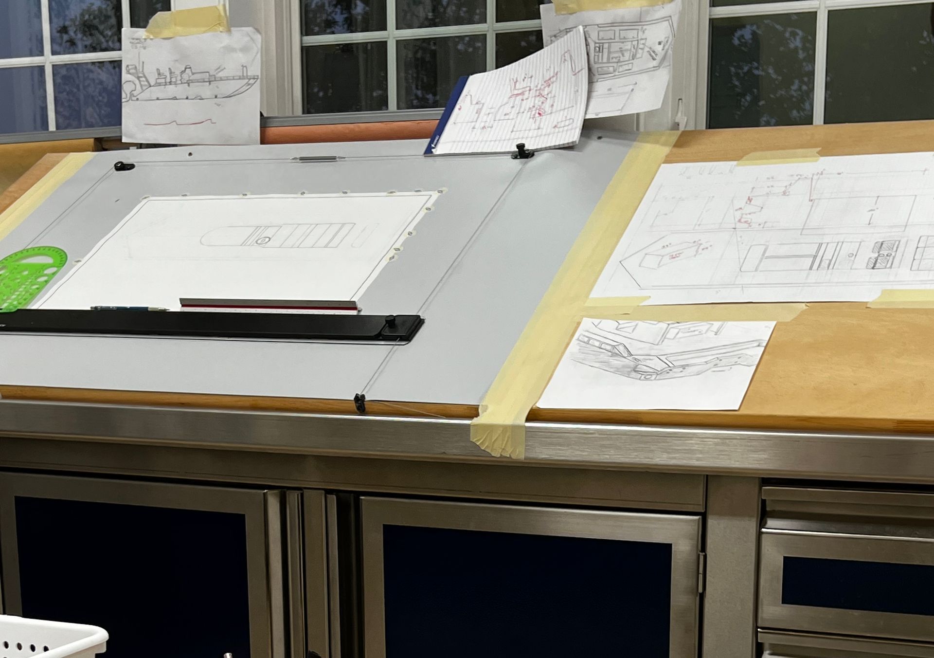 A table with drawings and a ruler on it