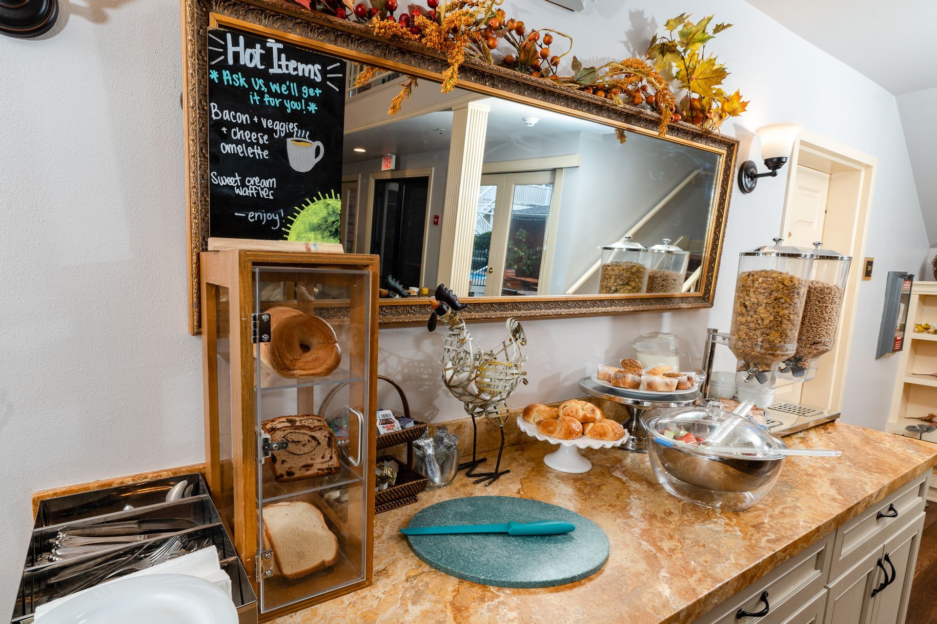 Bedroom with TV on dresser, desk with lamp, chair, and art on the wall.
