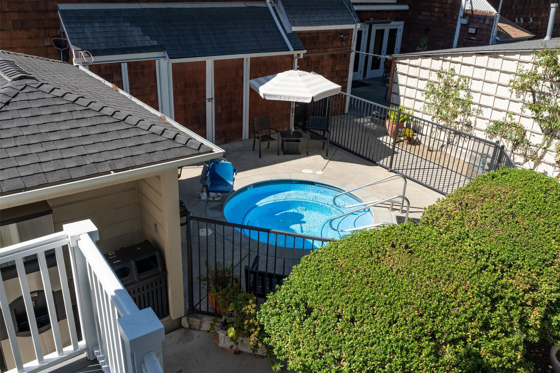 Towels hanging on a rack in a bathroom, reflected in the mirror. Includes a black 