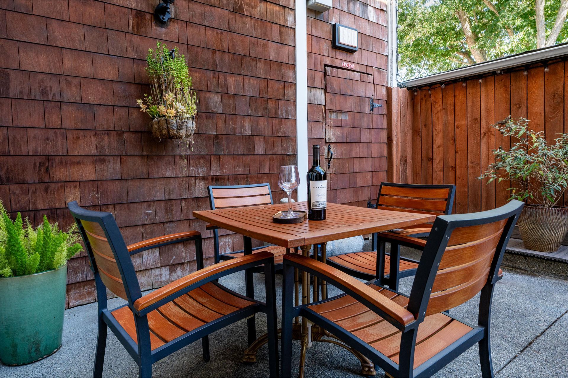Hotel room with king bed, wooden furniture, and green accent wall.