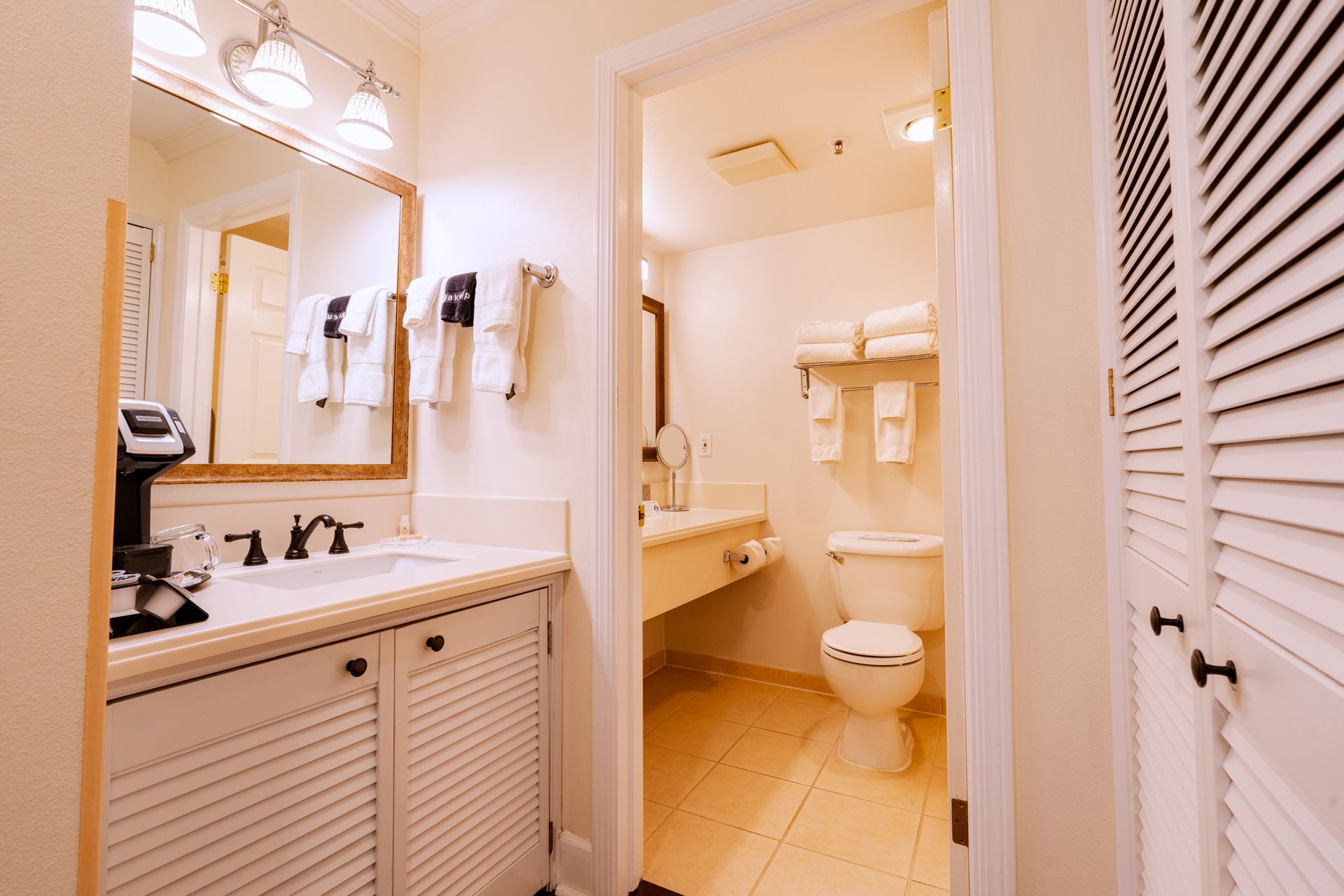 Bathroom interior with a sink, mirror, and toilet visible.