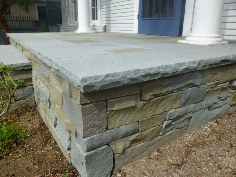 A stone wall with a porch