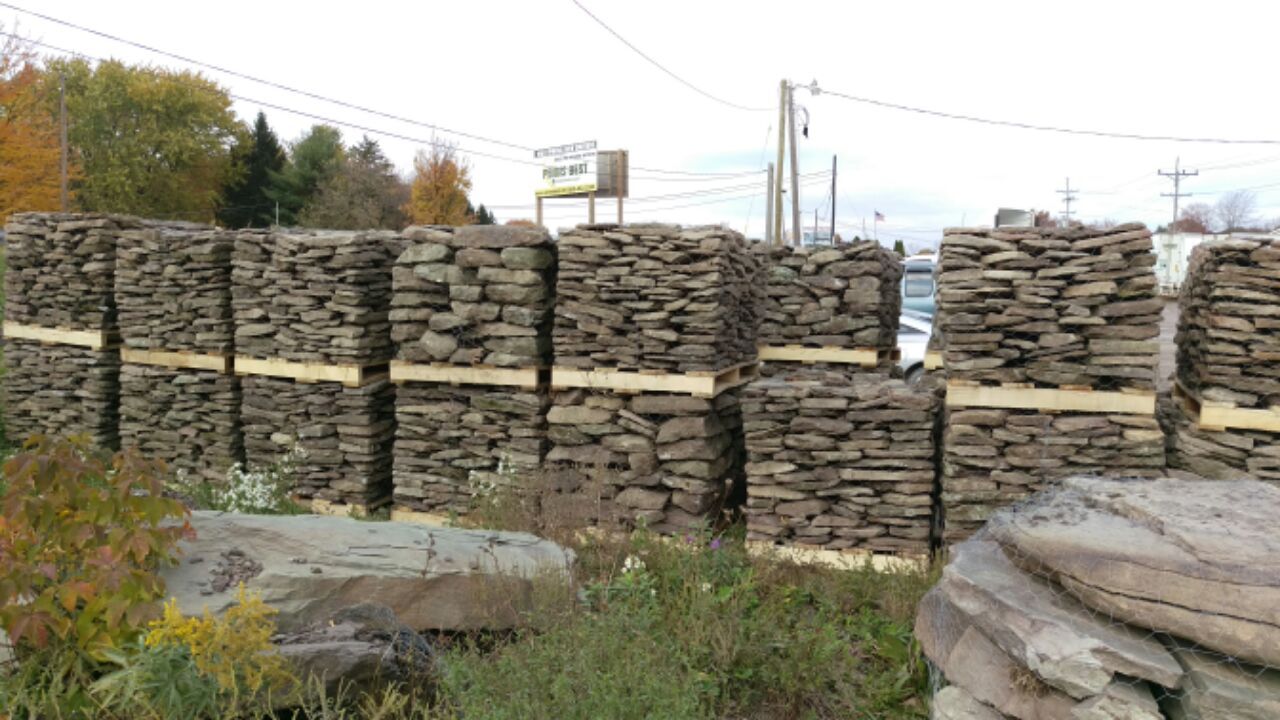 A pile of rocks stacked on top of each other in a field.