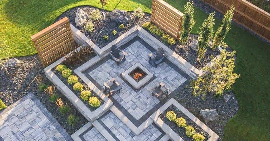 An aerial view of a patio with a fire pit and chairs.
