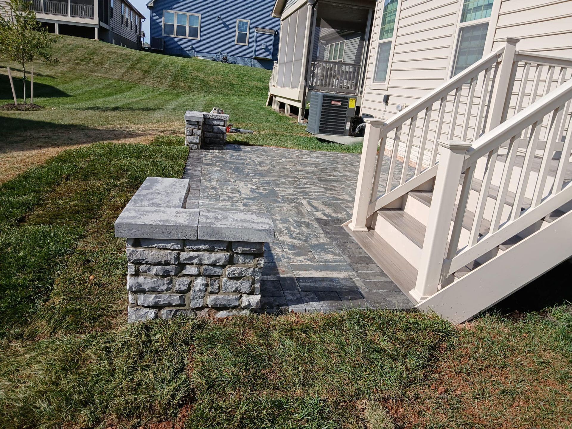A house with a patio and stairs in front of it.