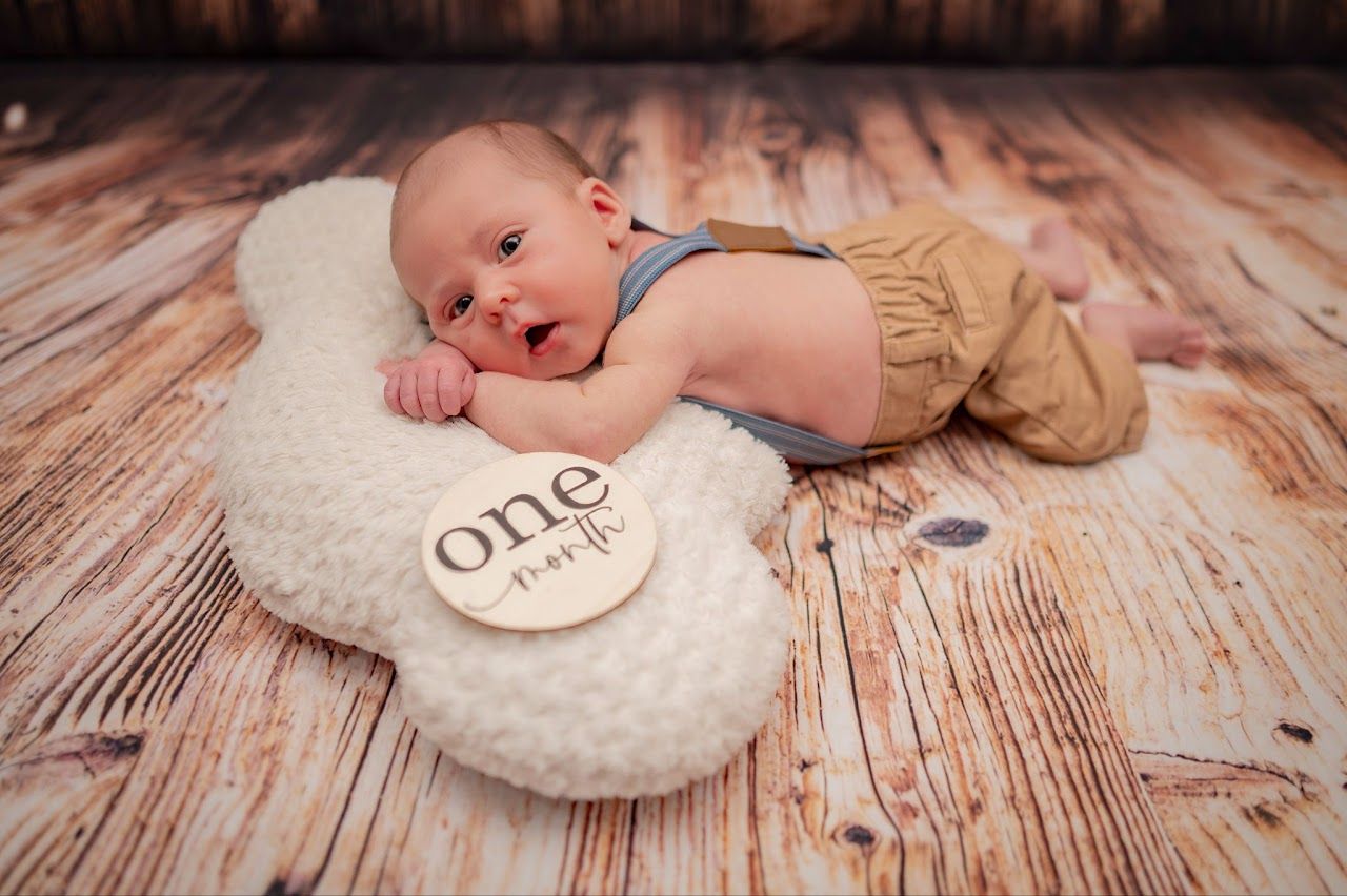 Baby boy on a fluffy pillow with 