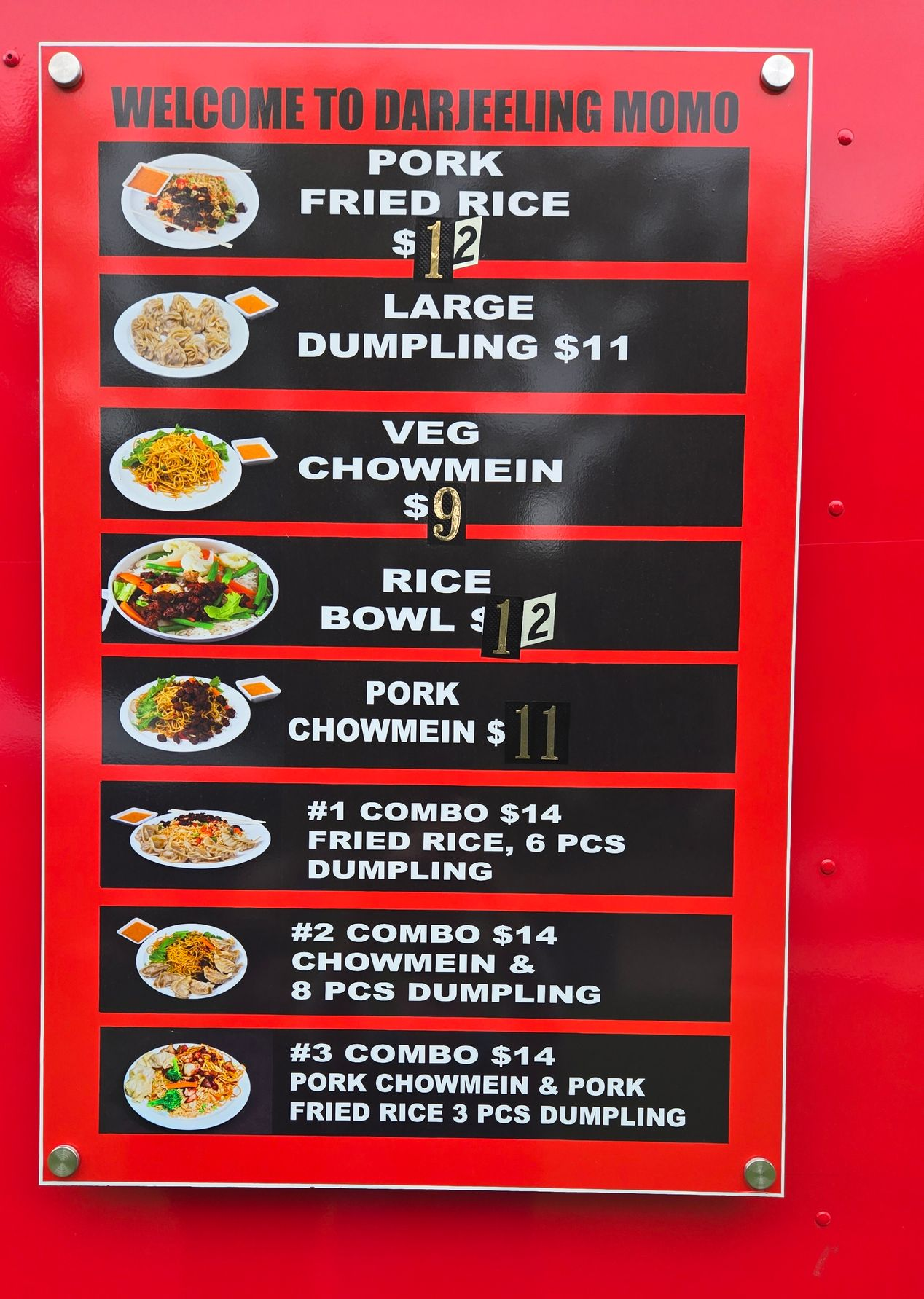 Menu board for Darjeeling Momo, a food vendor, offering pork fried rice, dumplings, chow mein, and rice bowls.