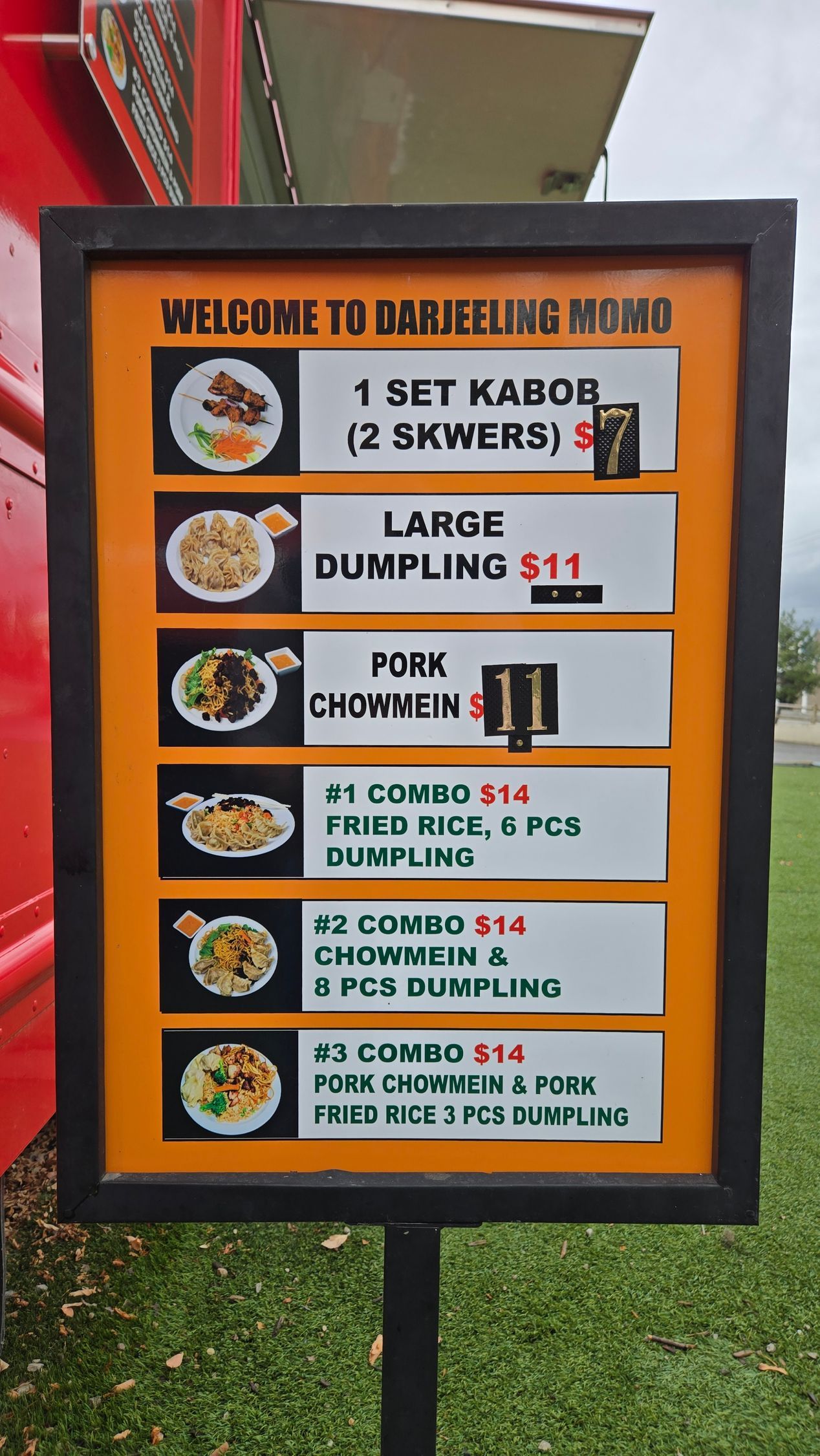 Menu sign for a food truck with photos and prices of various dishes.