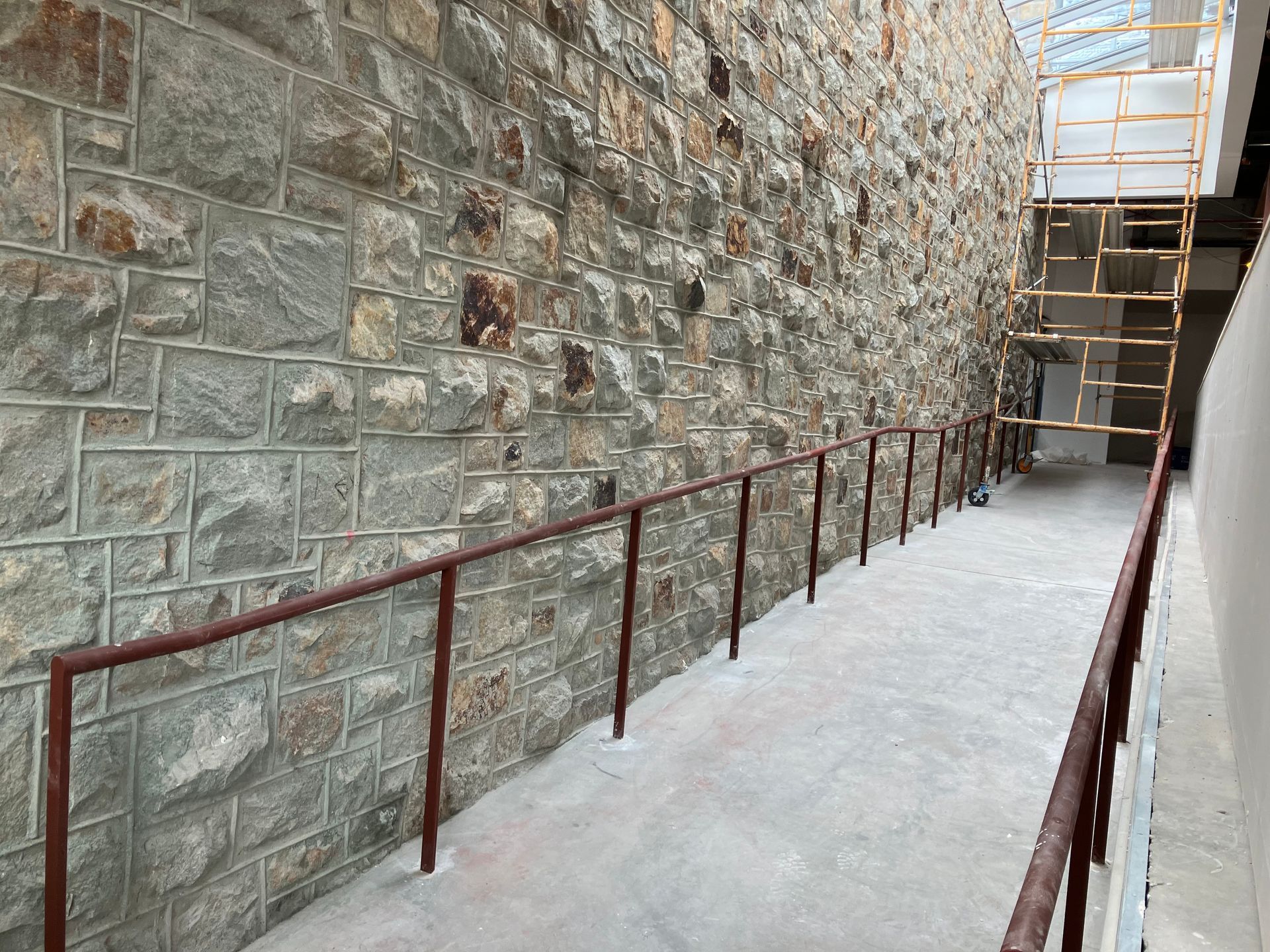 A stone wall with stairs leading up to it