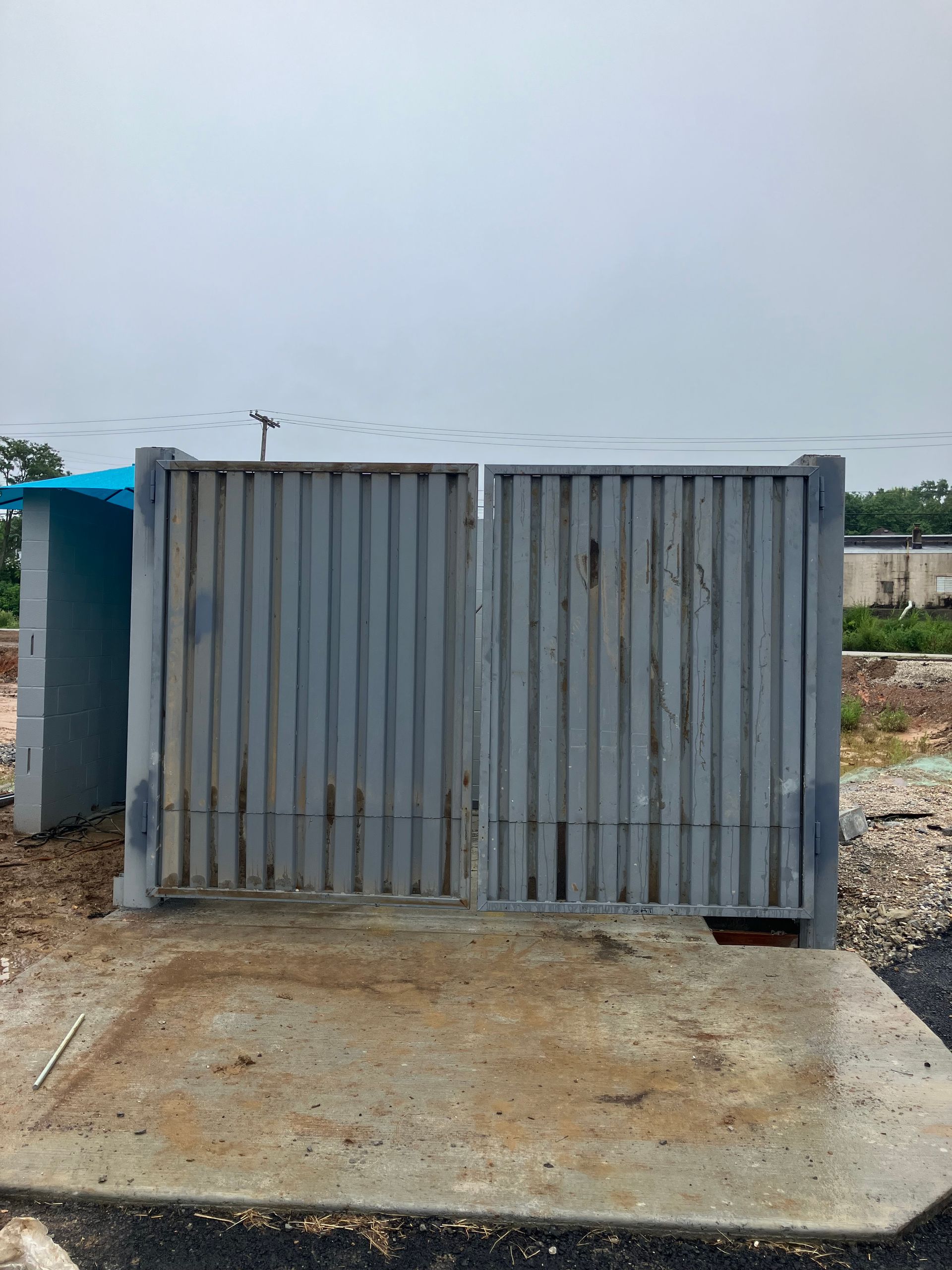 A metal fence is sitting on top of a concrete platform.