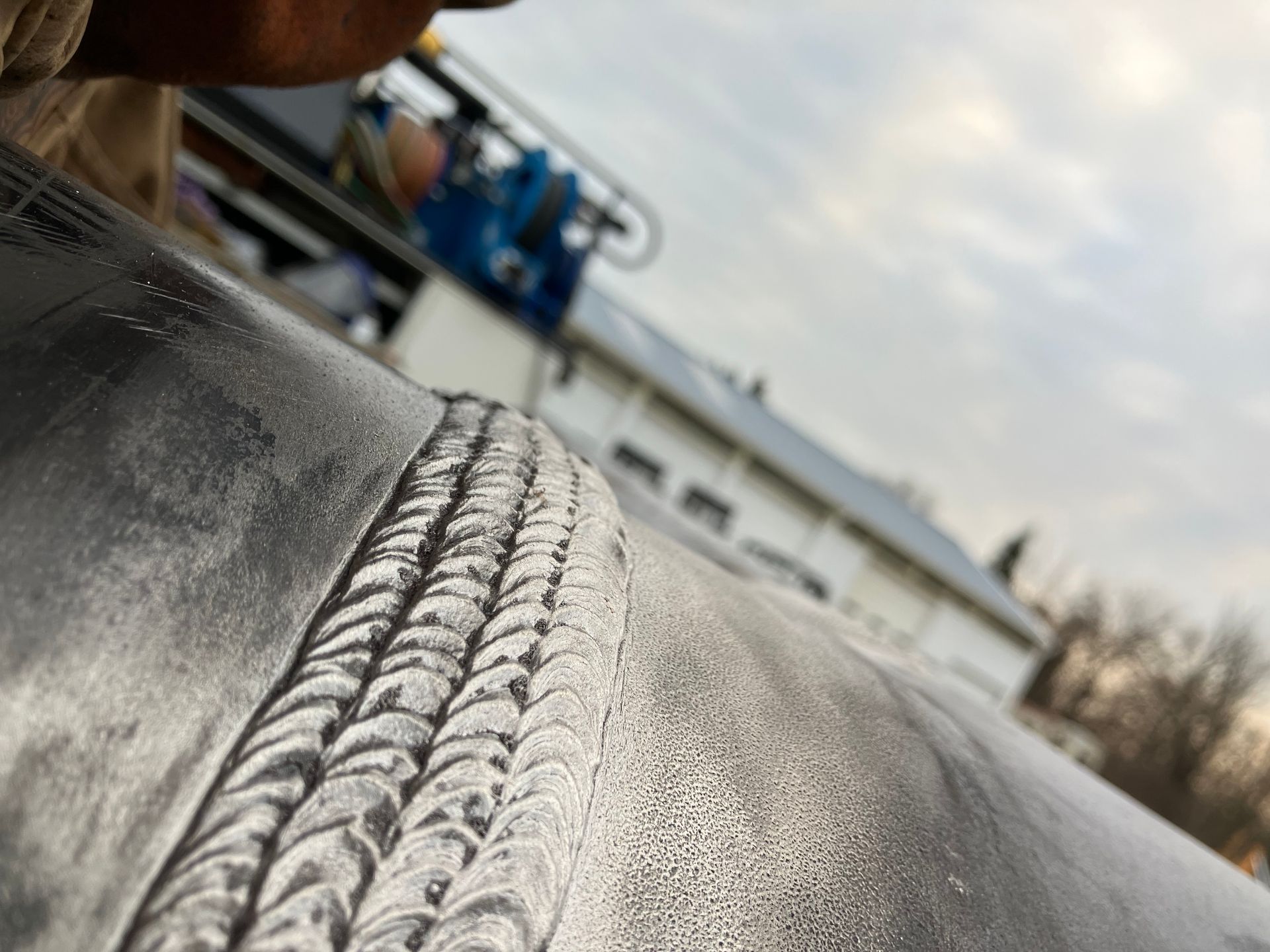 A close up of a person welding a piece of metal