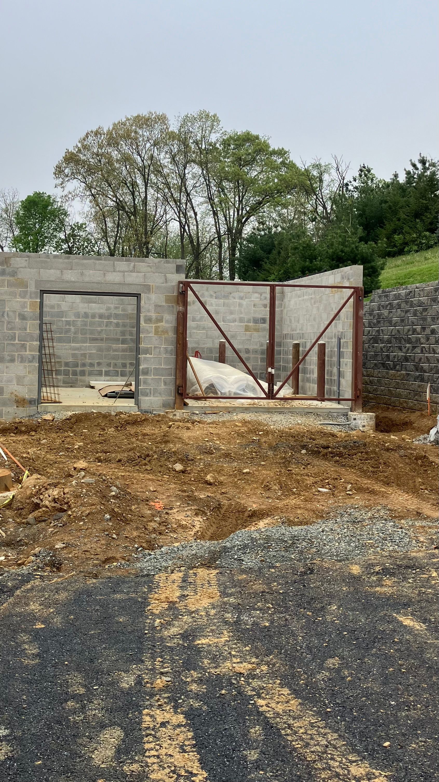 A building is being built in the middle of a dirt field.