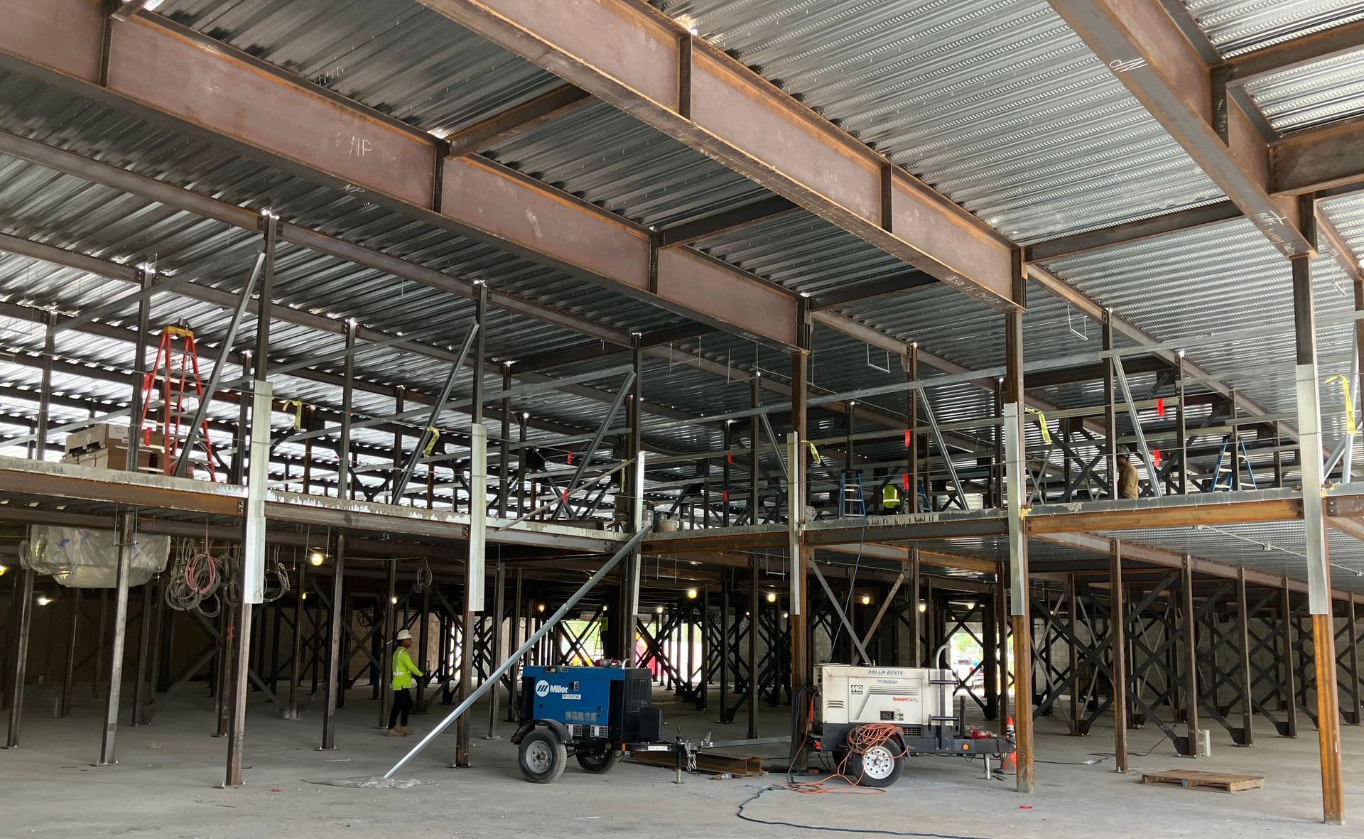A large building under construction with a lot of metal beams