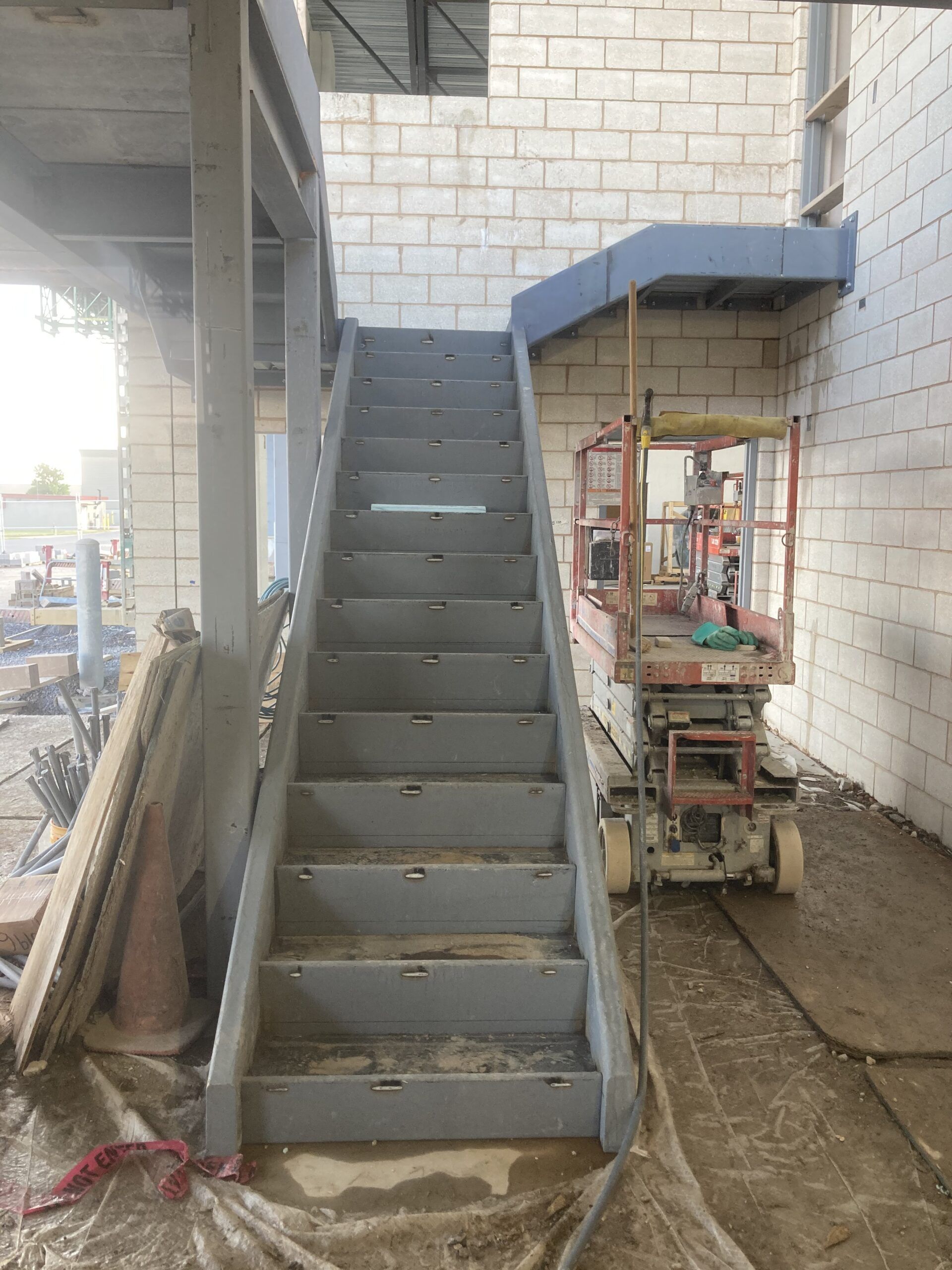A set of stairs leading up to a building under construction.