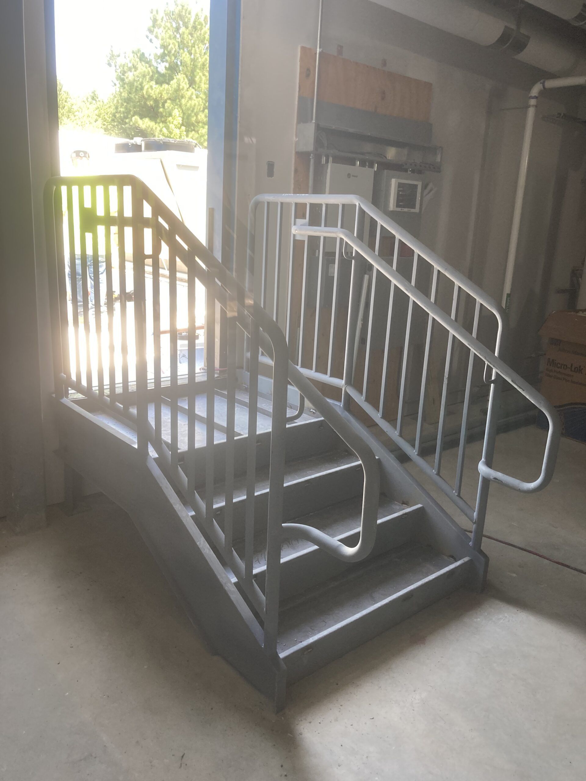 A set of stairs with a metal railing in a building