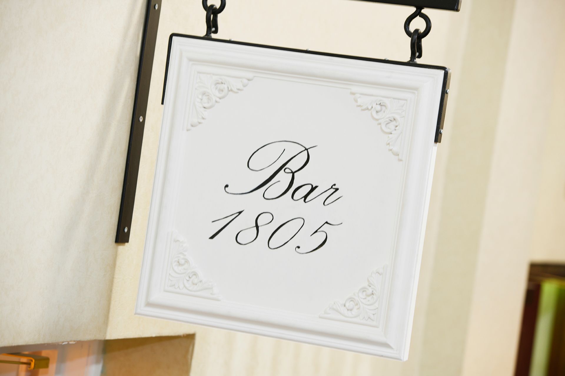 A white sign that says bar 1805 on it