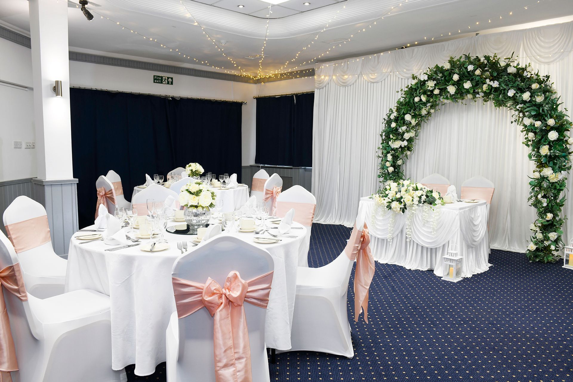 A table set for a wedding reception with flowers on it