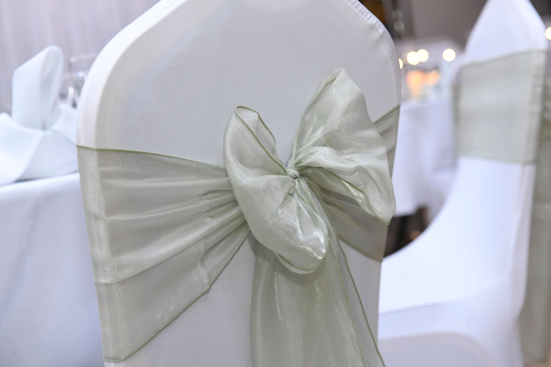 A close up of a chair with a bow on it.