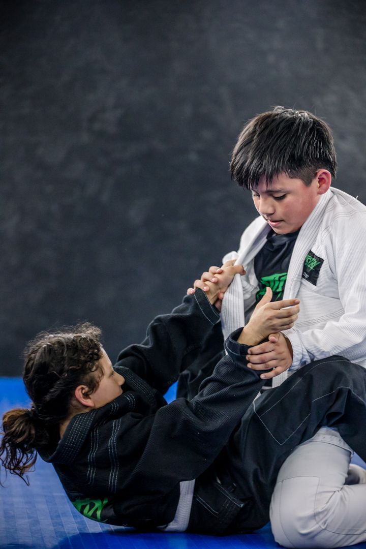 Students drilling Brazilian Jiu Jitsu at Artistry BJJ in Houston, TX to build focus.